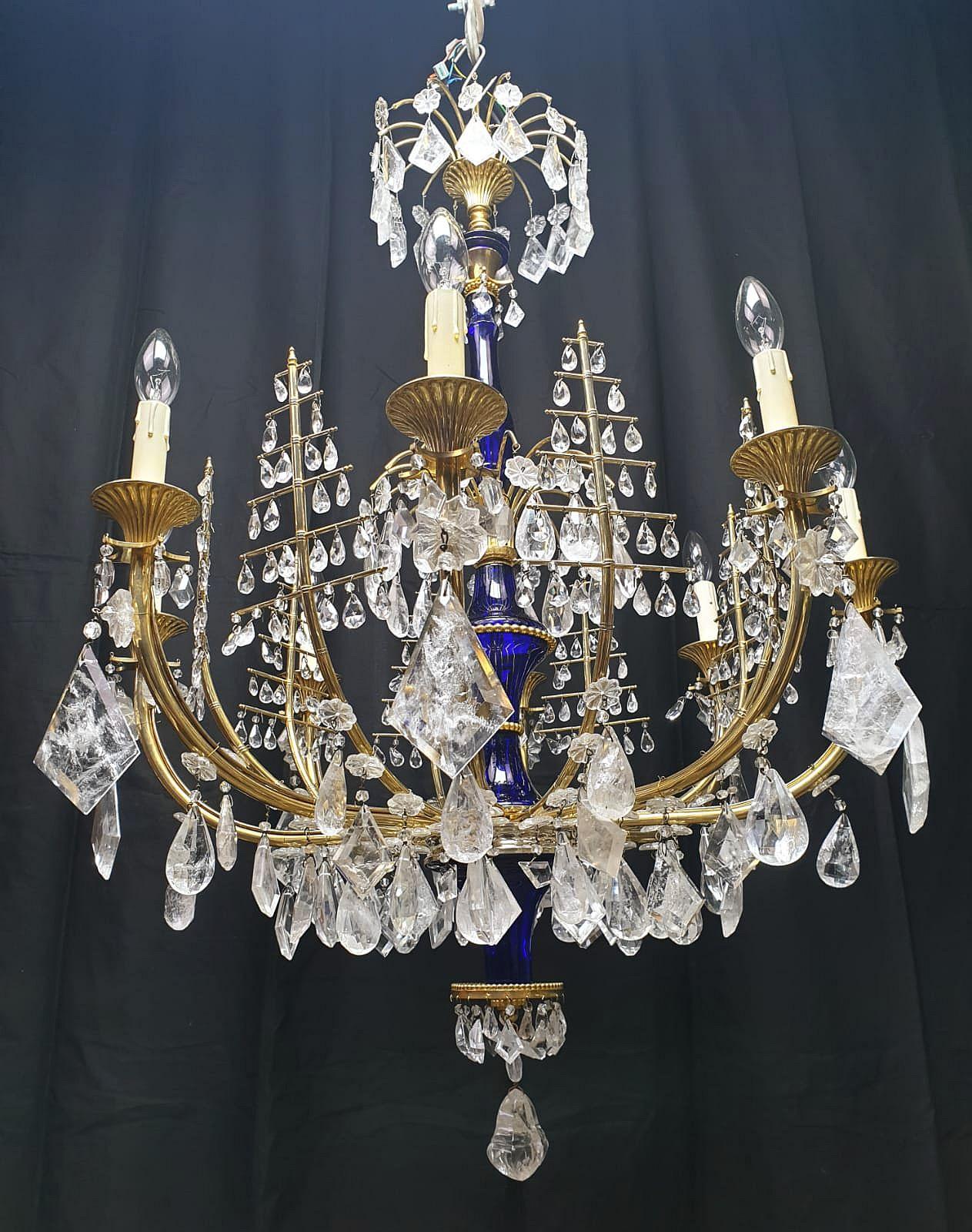 Very sophisticated, elegant neoclassical eight-armed rock crystal chandelier with a cobalt glass baluster. Between its arms are eight rock crystal hangings in form of trees. Northeastern European chandeliers have a characteristic lightness between