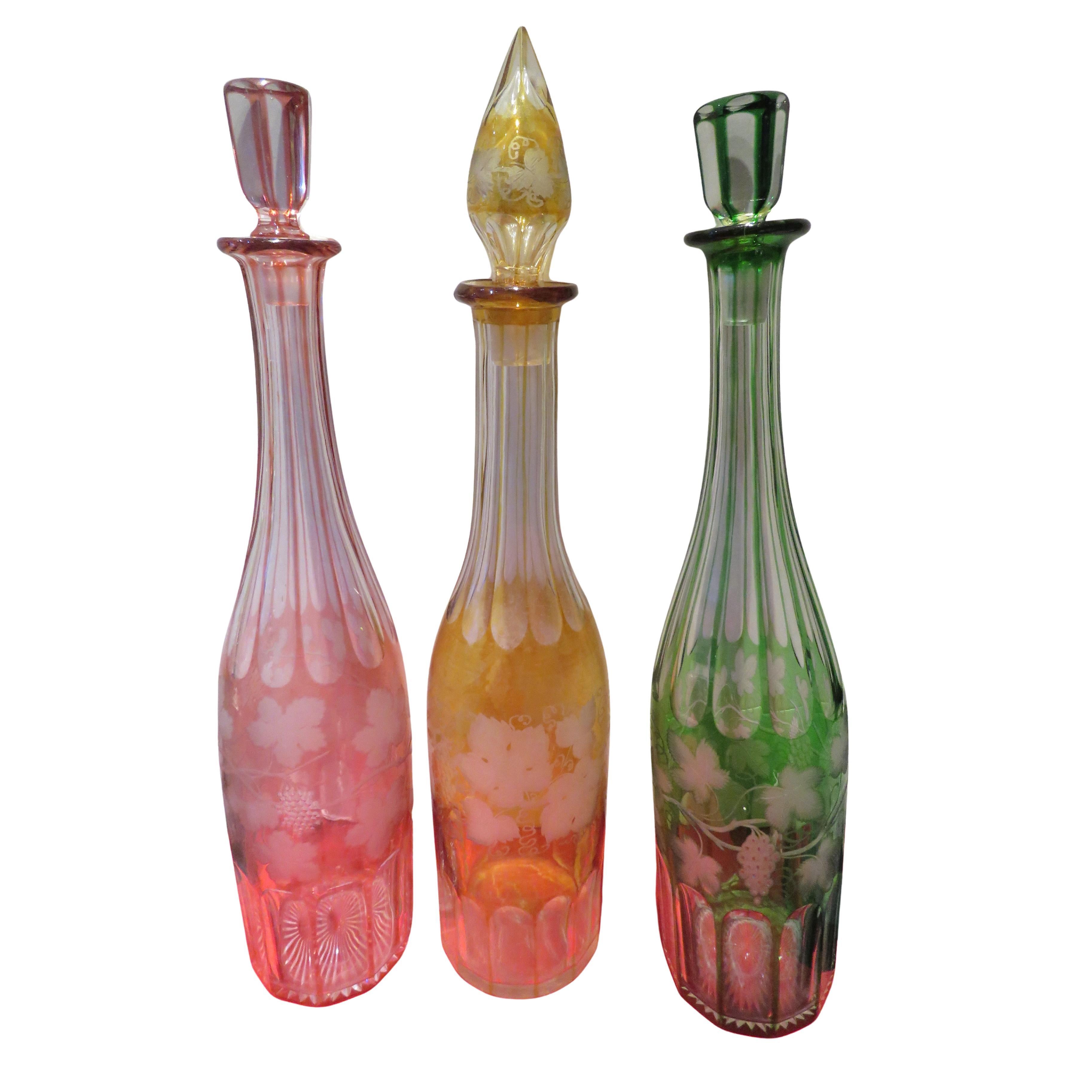 Important Set of 3 Cranberry Red Amber Emerald Crystal Glass Decanter Bottles