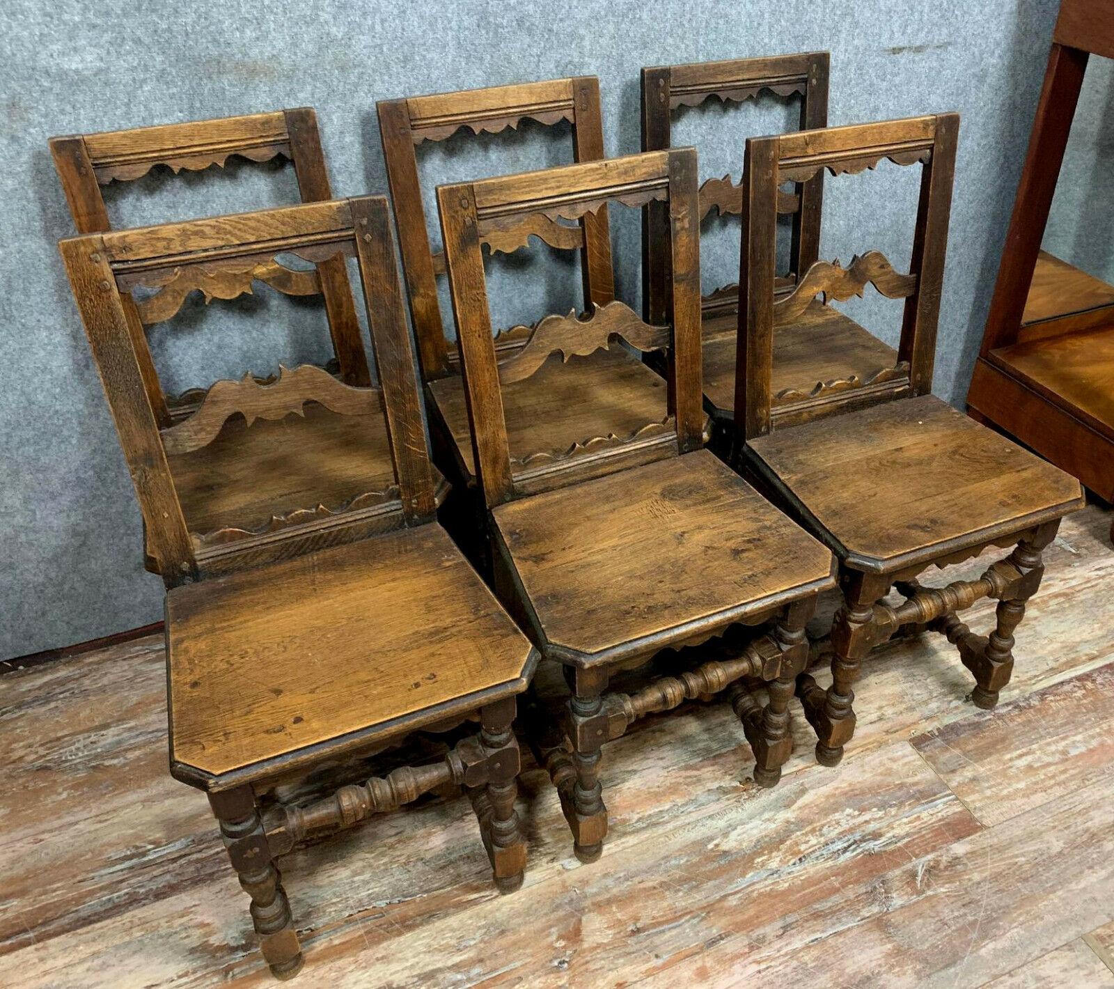 Elevate your dining space with this significant set of six Lorraine chairs, crafted from solid oak and dating back to the mid-19th century. These chairs embody the timeless elegance and sturdy craftsmanship characteristic of the Lorraine style,