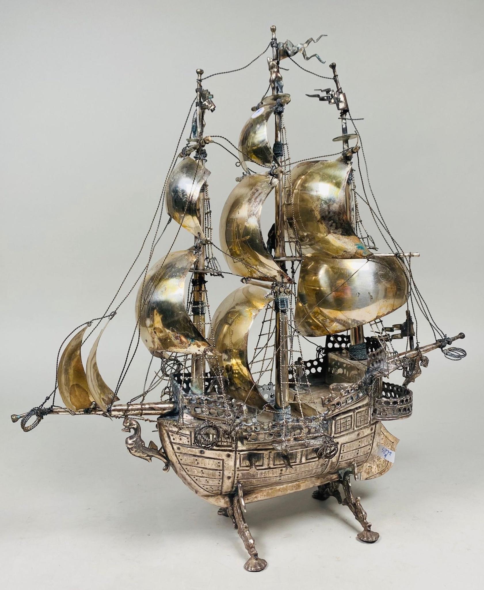 A nef is an extravagant table ornament and container used in the Middle Ages and Renaissance, made of precious metals in the shape of a ship. 
Important and opulent south Europa silver plate nef. 
The nef takes the form of galleo: Three masts and