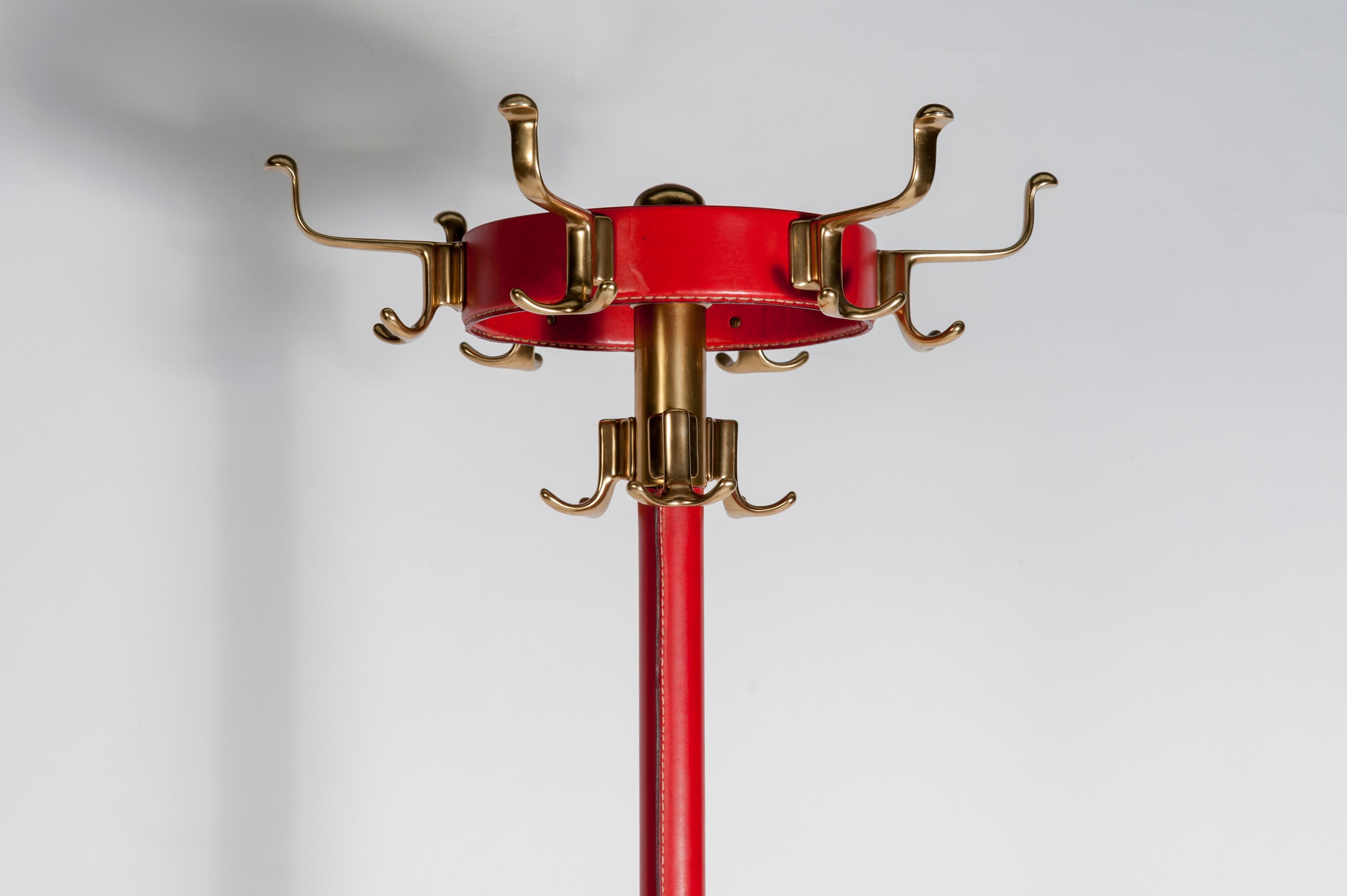 Rare red stitched leather coat rack by Jacques Adnet.