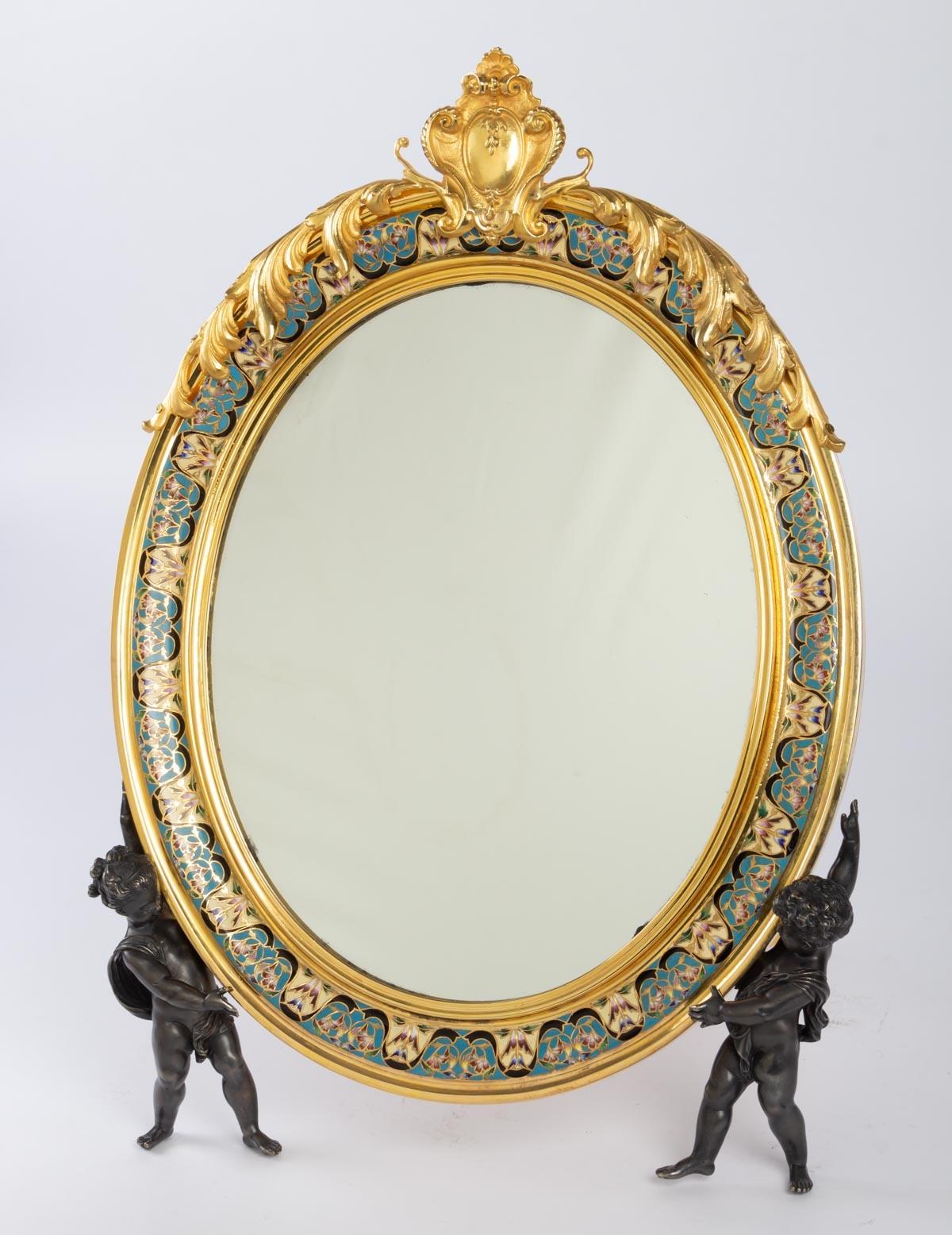 Important 19th century toilet mirror, Napoleon III, bronze and cloisonné enamels, supported by two small cherubs, the openwork pediment decorated with a rocaille cartouche framed by a garland of flowers.
Late 19th century, Napoleon III