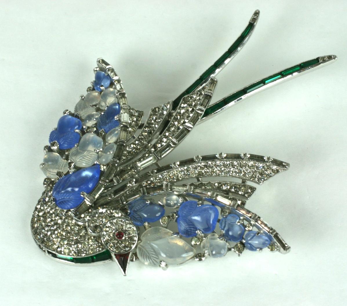 Rare Trifari Alfred Phillippe massive bird brooch of rhodium plate base metal. The wings are ornamented with white opal and  blue faux chalcedony molded and engraved glass vari size fruit salad stones. The body of the wings of crystal rhinestone