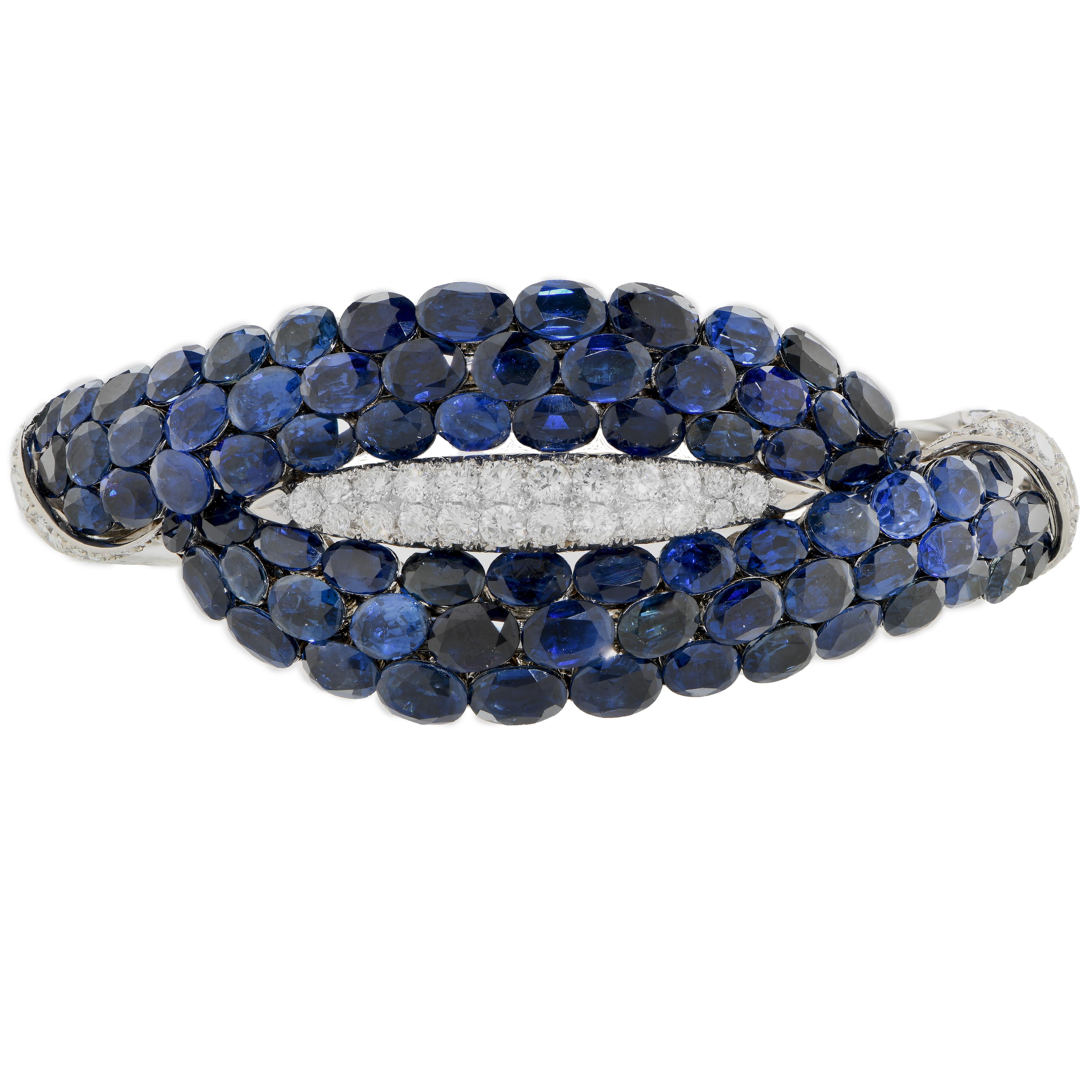 This Important and Rare Van Cleef & Arpels hand crafted beautiful bangle features 76 oval cut sapphires and 36 round brilliant cut diamonds hand set in Platinum and 18 Karat White Gold. Circa 1963.
This wonderful bracelet will become the signature