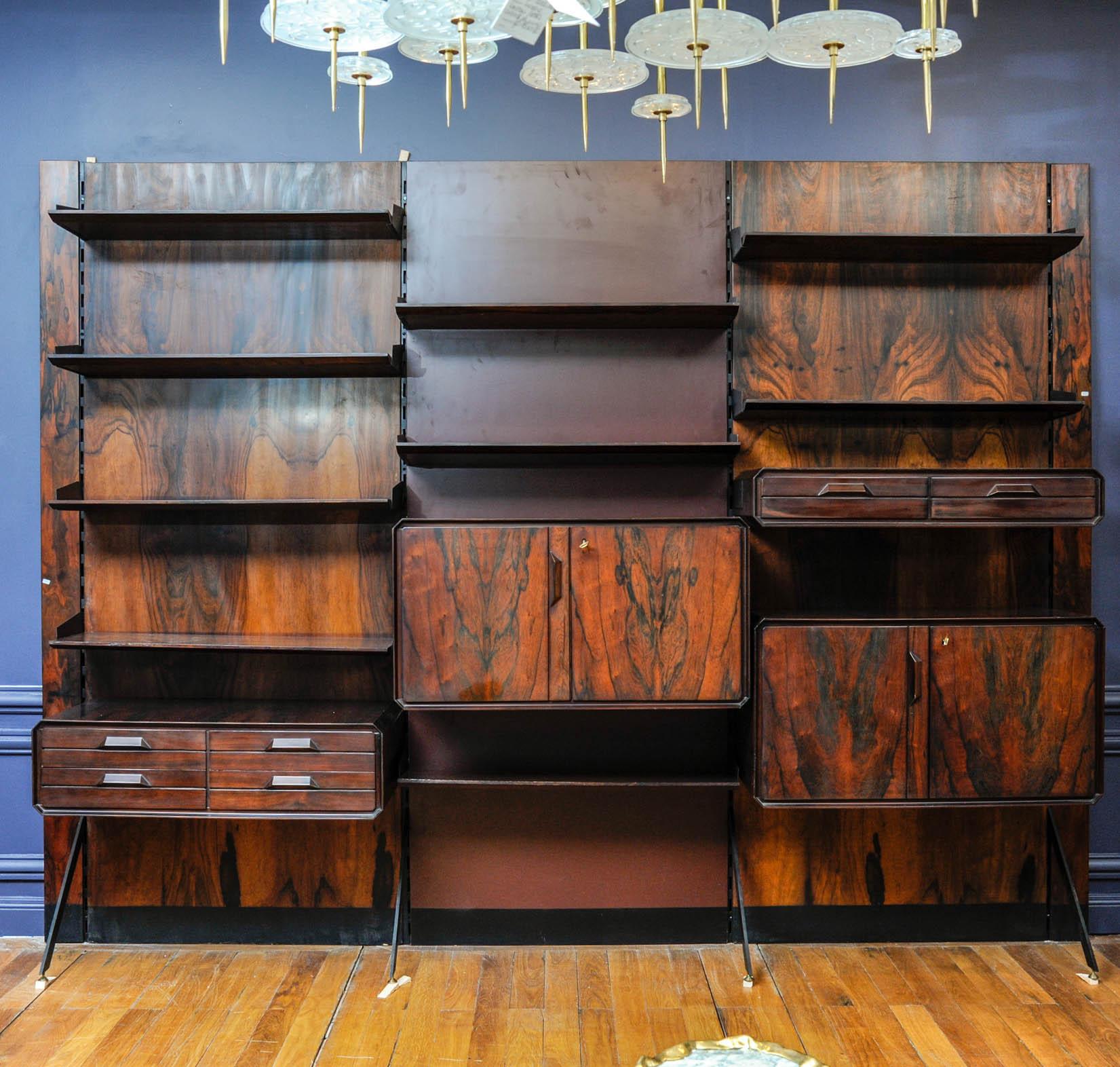 This very important bookcase in Rio palissander is composed of three parts and six drawers, shelves, two cupboards.