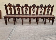 Important walnut bench, finely carved and inlaid, Italy