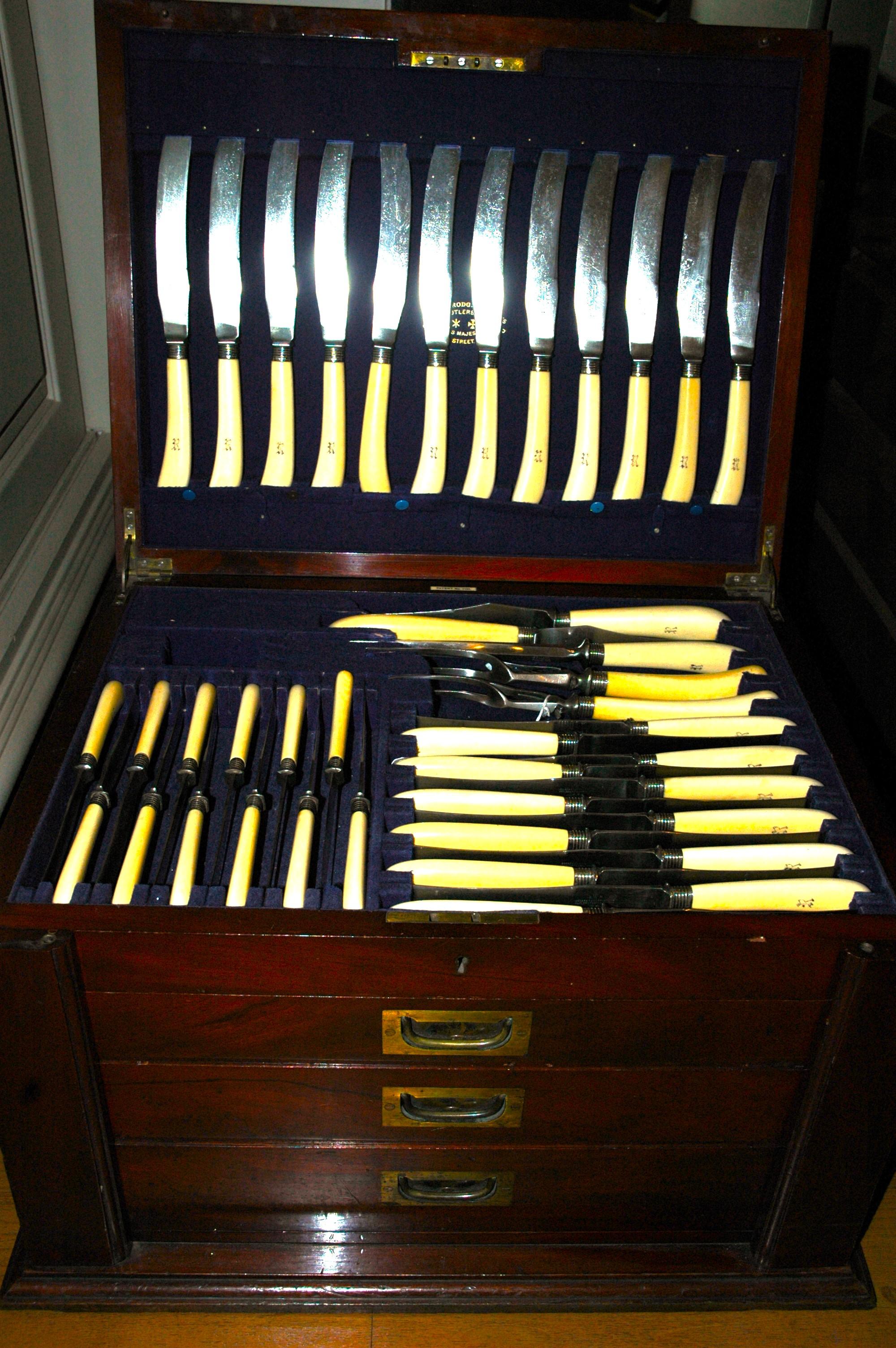 Antique silver, mother-of-pearl, and ivory cutlery service consisting of 177 pieces. It is contained in a special wooden cabinet. On the cabinet as on each flatware is the initial 