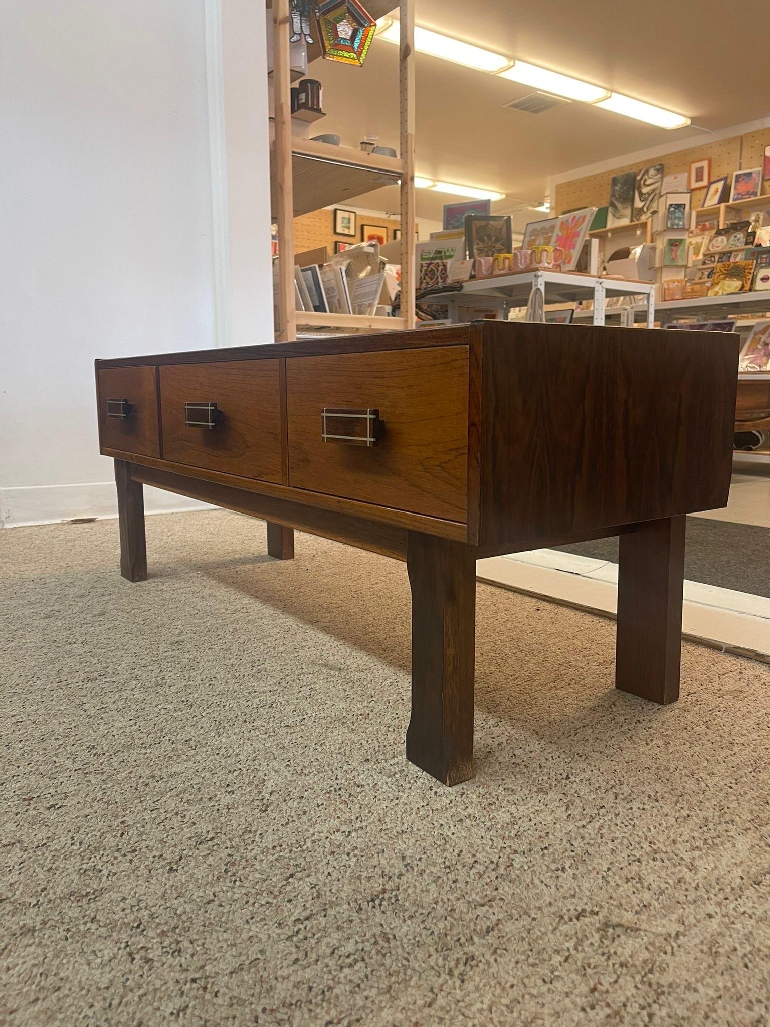 This Table features wood inlay accents on each of the three drawer pulls. Beautiful wood grain throughout. Imported From Denmark.Vintage Condition Consistent with Age as Pictured.

Dimensions. 43 W ; 14 D ; 16 1/2 H