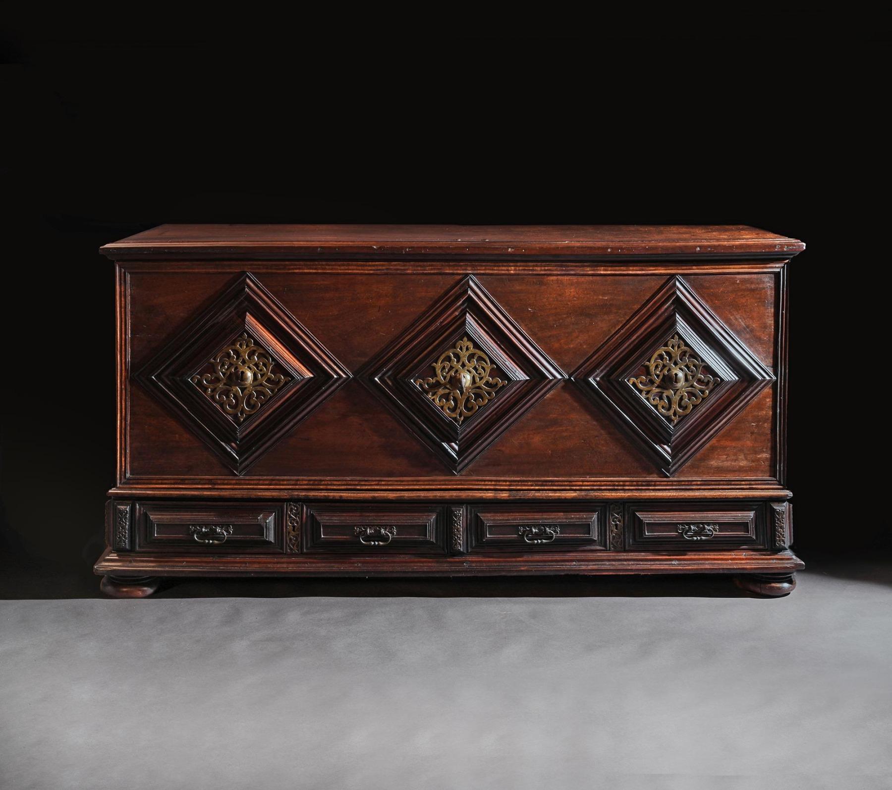 An imposing 17th century mahogany Portuguese colonial trunk / chest, of grand proportions, decorated with pierced brass panels.


Probably Brazil, circa 1670.


This rare chest is of Iberian design, that first emerged in the 16th century with