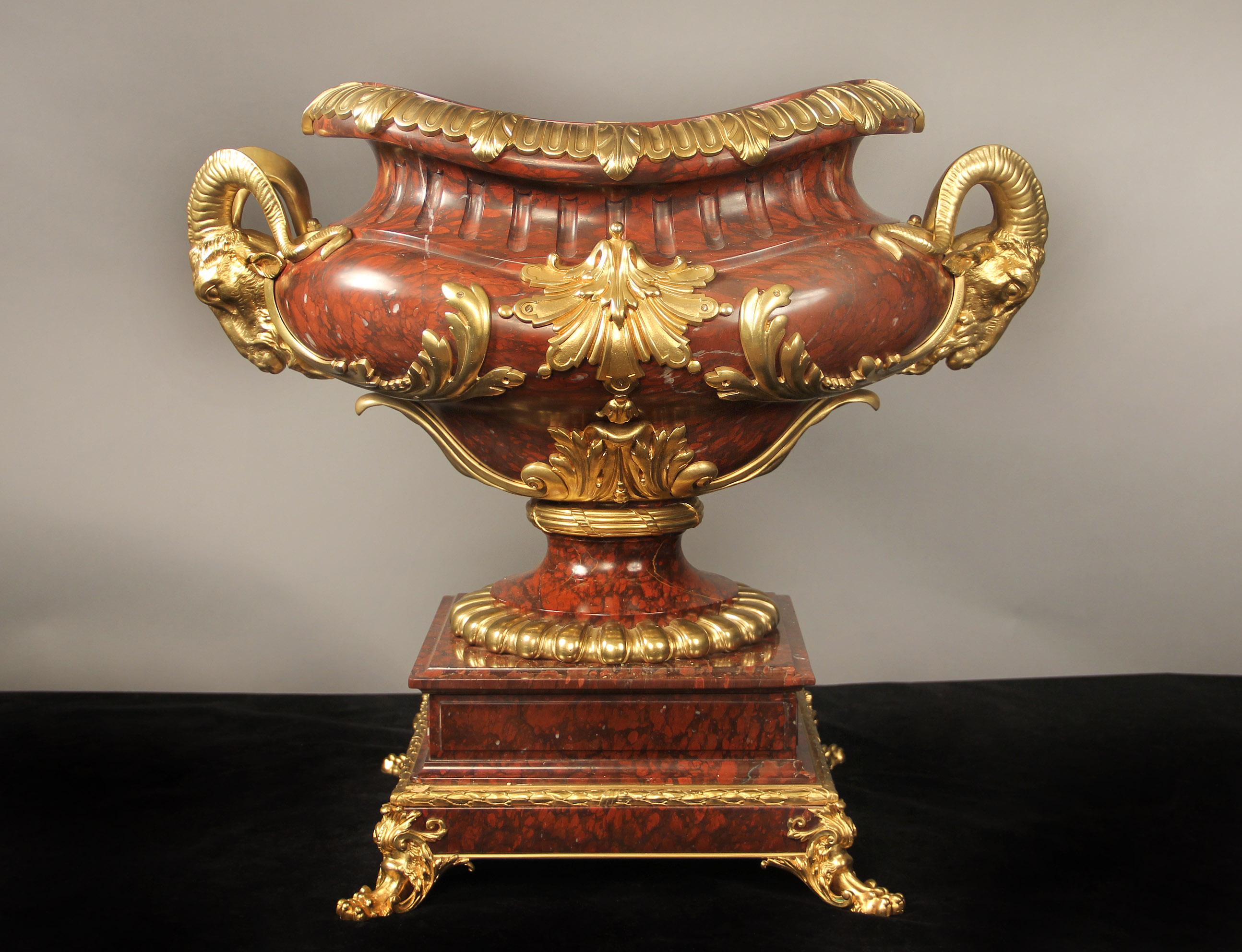 An imposing late 19th century Napoleon III gilt bronze mounted rouge griotte marble jardiniere by Barbedienne

Ferdinand Barbedienne

The oval waisted neck with gadrooned surround mounted with acanthus leaves, the bulbous body centered to the front