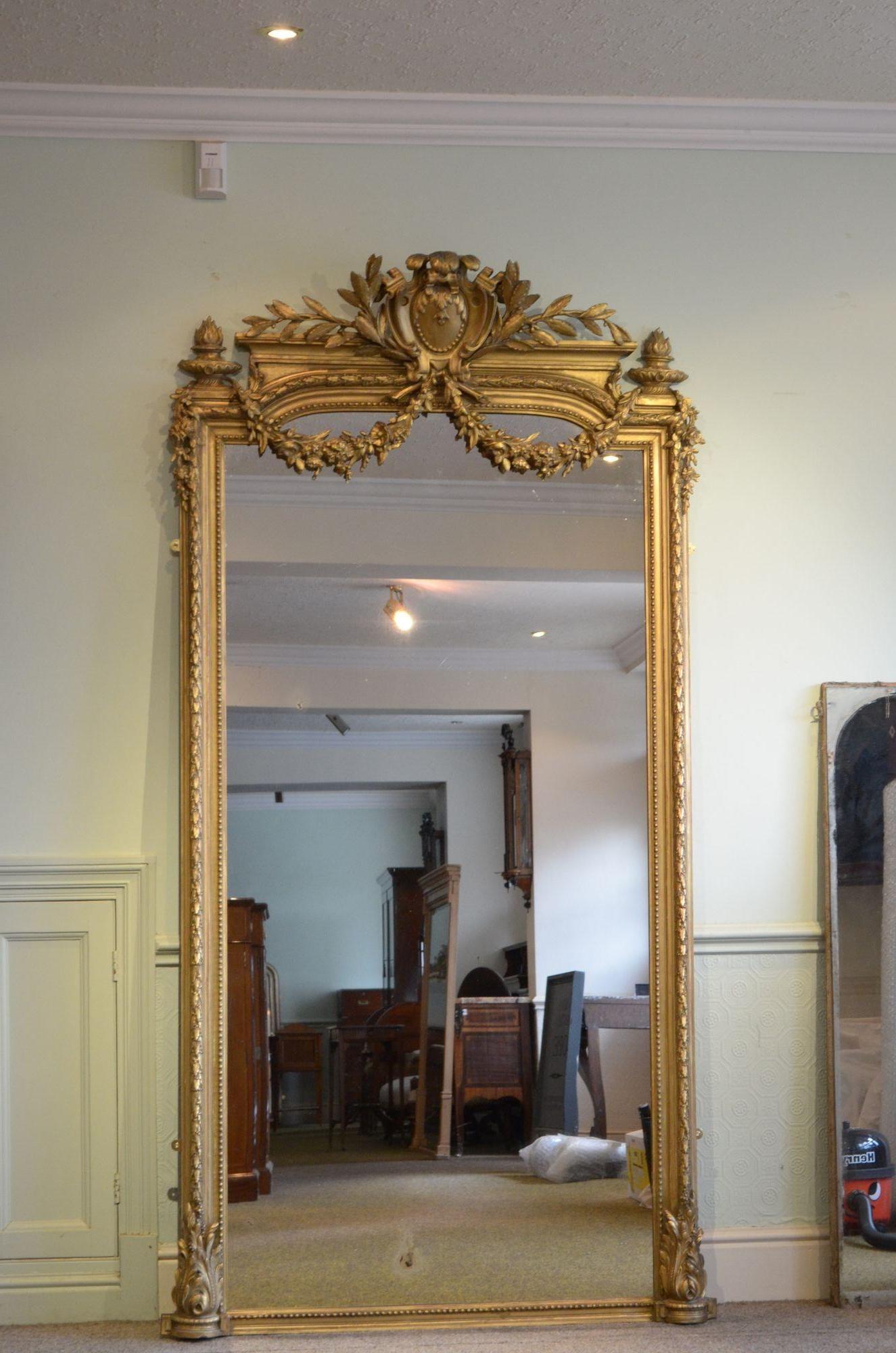 Sn5388 outstanding 19th century French giltwood mirror, having original glass with some foxing and air bubbles in gilded and moulded frame with beaded edge, laurel leaf carving, acanthus scrolls to the base and finely carved crest with floral swags