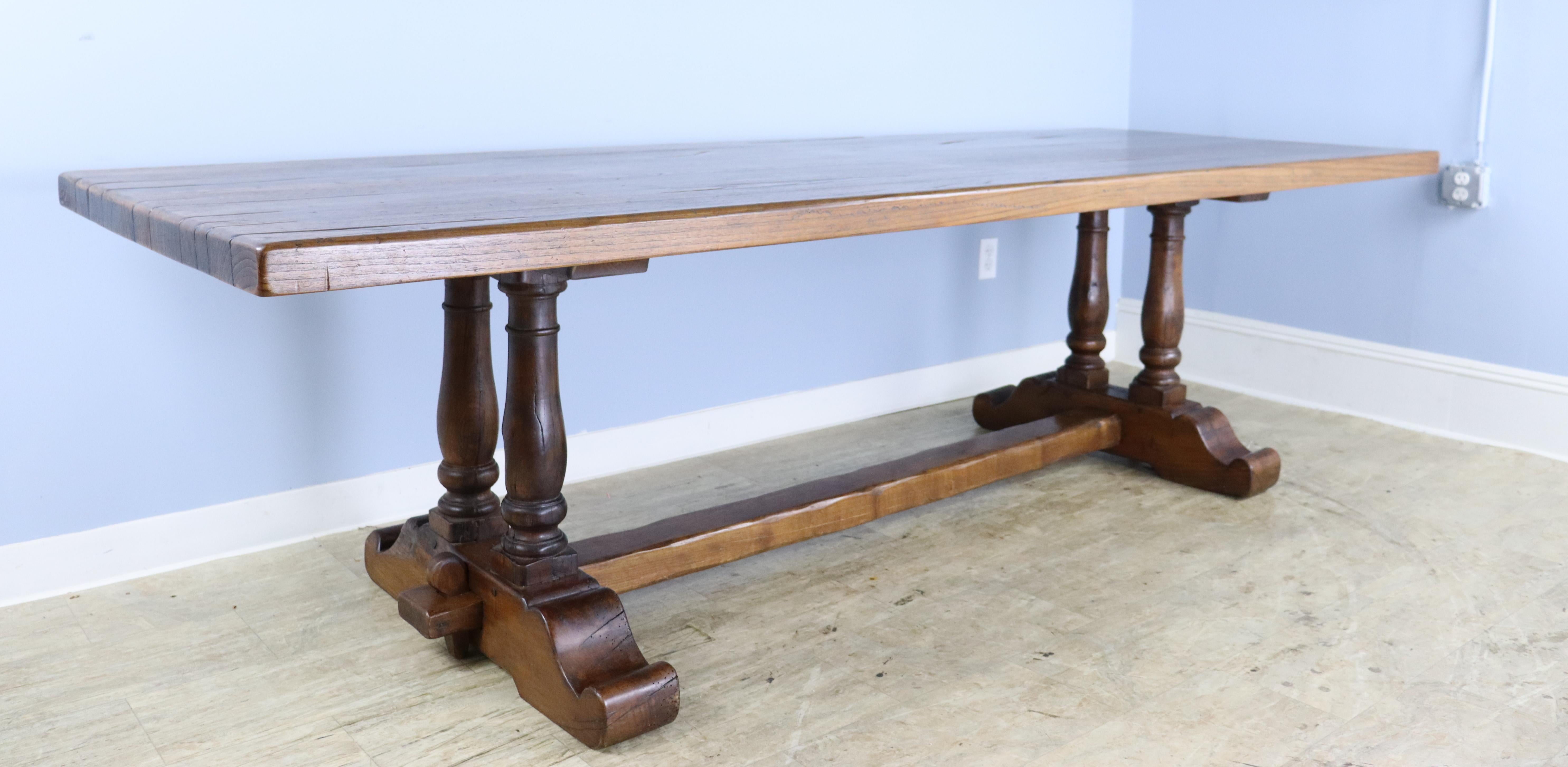 An eye catching oak dining table with stunning double barrel legs and a pretty trestle base.  The 2.25