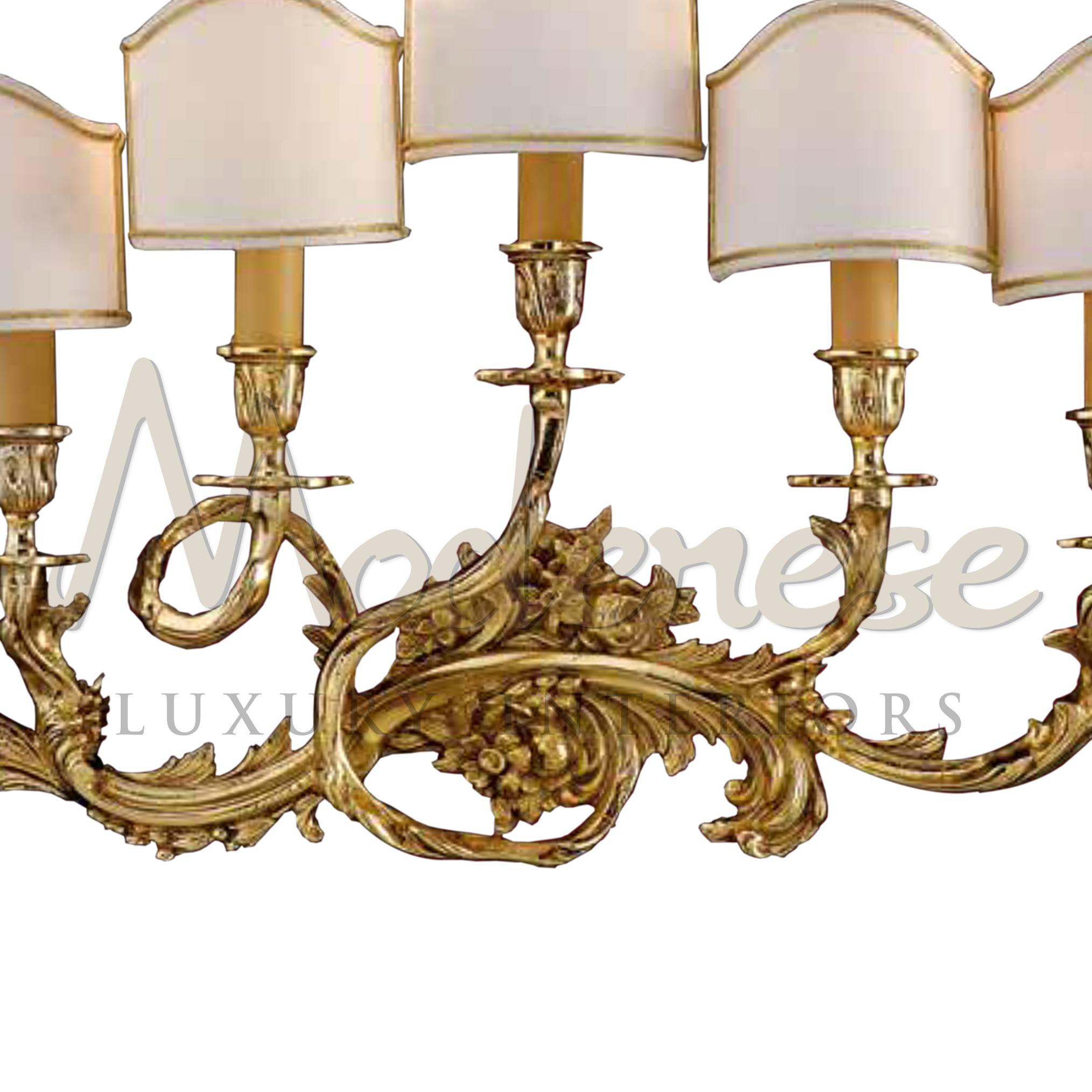 Luxury lighting by Modenese Luxury Interiors are distinguished by innovative design, materials of the highest quality and sophisticated style, mixing lampshade and solid brass, all covered in 2kt antique gold plated finishing. This model requires 5