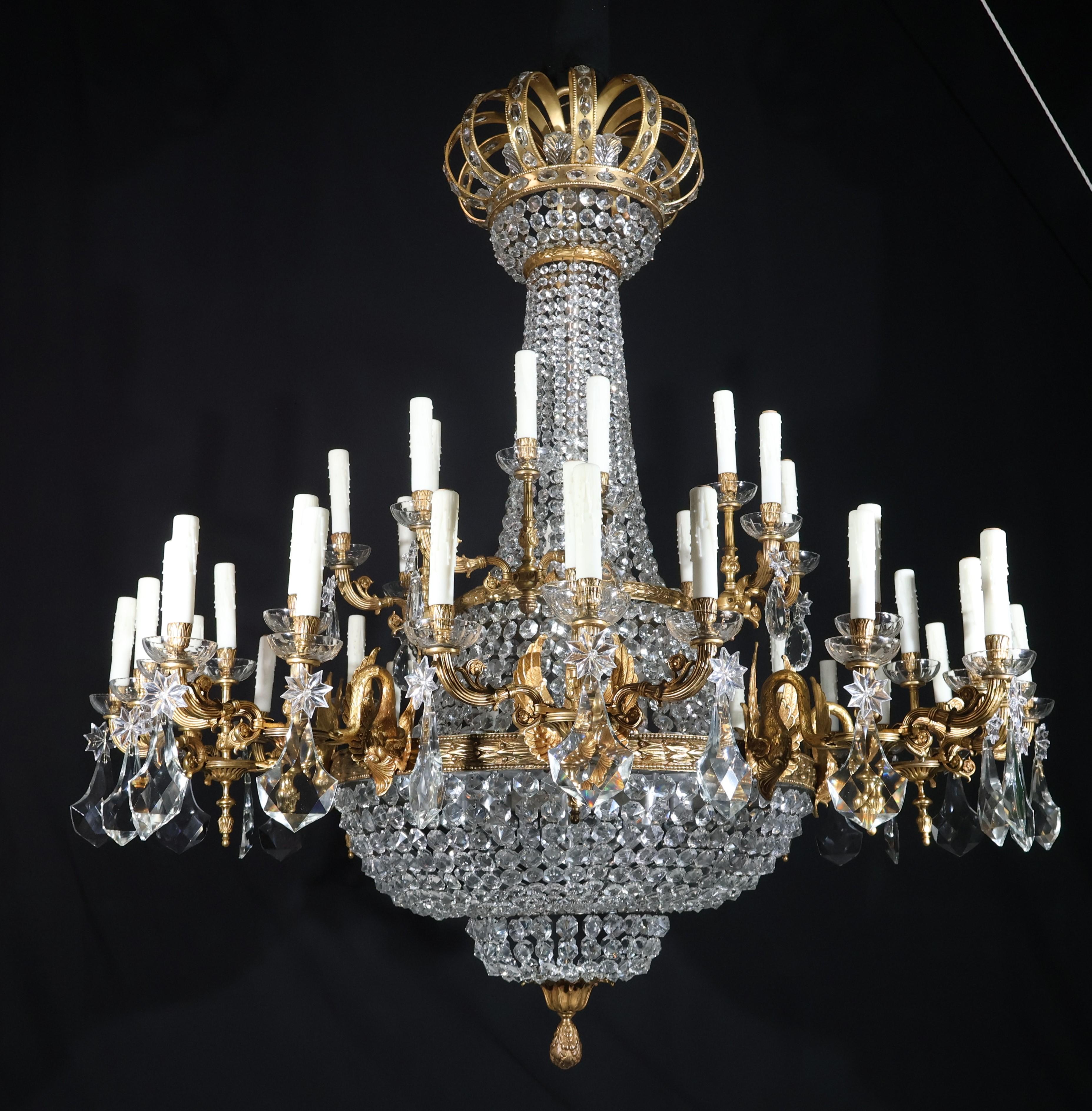 Magnifico lampadario in bronzo dorato a 60 luci in stile Luigi XVI con catene e pendagli in cristallo. Francia, circa 1920
Dimensioni: Altezza  60