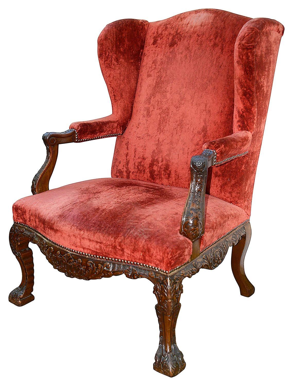 A very imposing and good quality pair of 18th century style Georgian Mahogany Gainsborough wing arm chairs, each with fine hand carved decoration to the arms, frieze and elegant cabriole legs. Silk velvet upholstery (showing some ware)

Batch 71