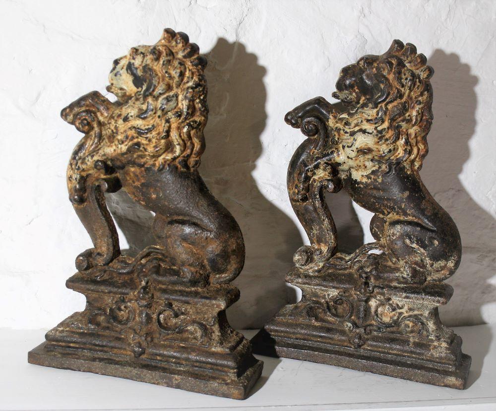 A good quality pair of of Cast iron door porters in a 'Lion Sejant Erect' form or sometimes termed 'sejant-rampant' - and in the manner of the coat of arms of dominion of the British Royal Monarch.
In their original state with some original white