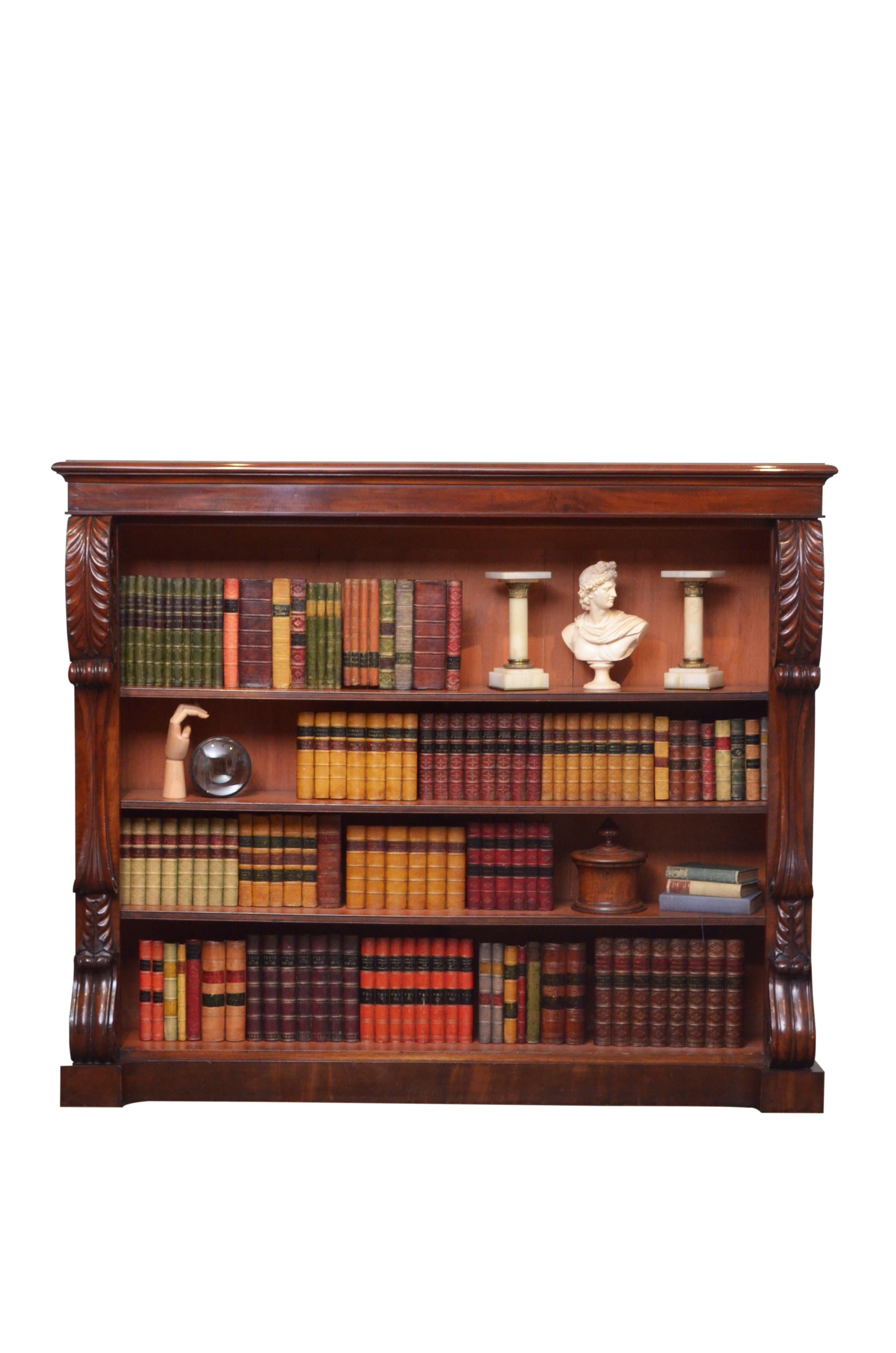 0586 Superb William IV open bookcase in mahogany, having figured mahogany top with moulded edge above shallow frieze and three shelves, all flanked by carved pilasters with outstanding acanthus leaf decoration to the top and fine scrolls to the