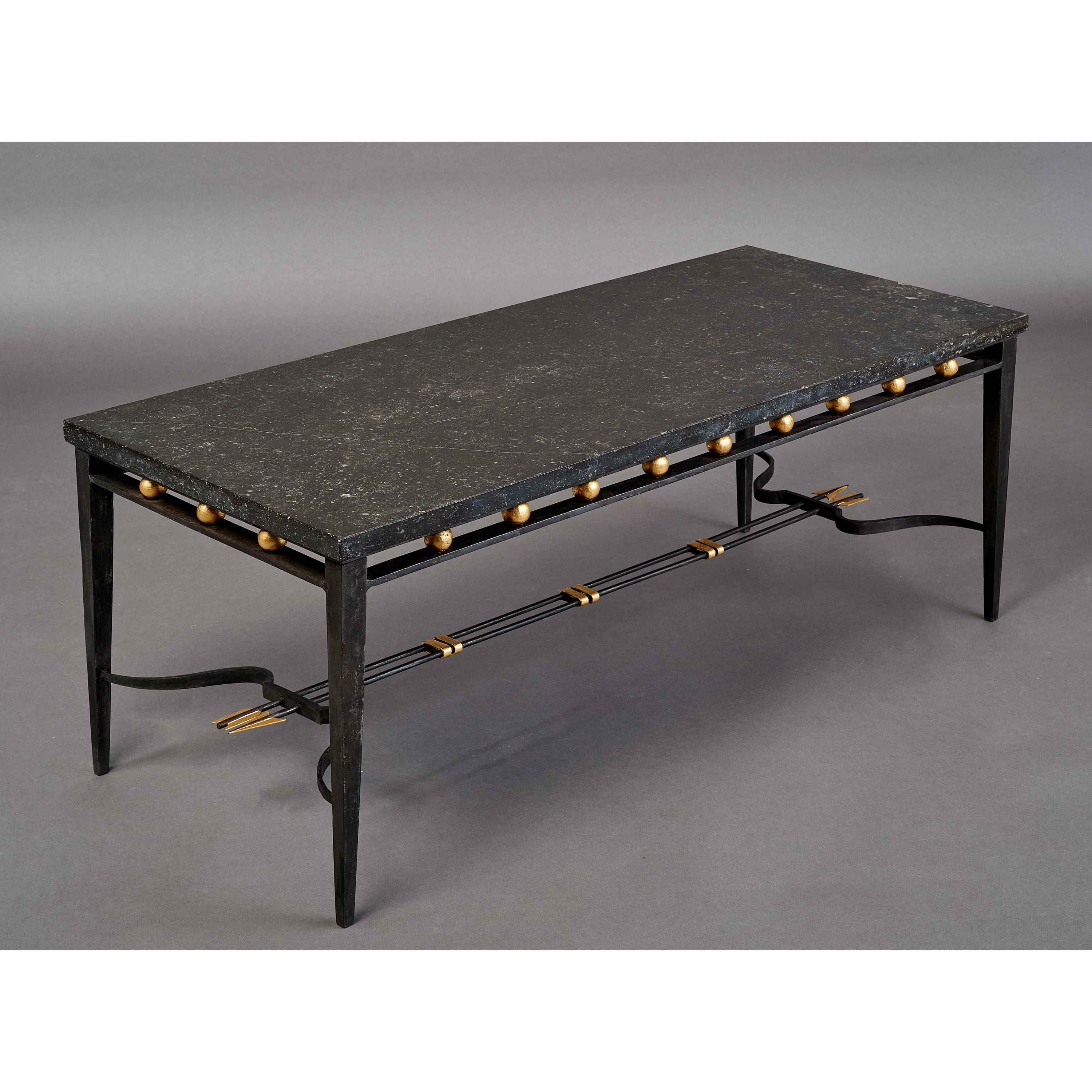 FRANCE, 1950's
Imposing wrought iron coffee table with Neo classical gilt decor of bows and arrows, the massive 1 