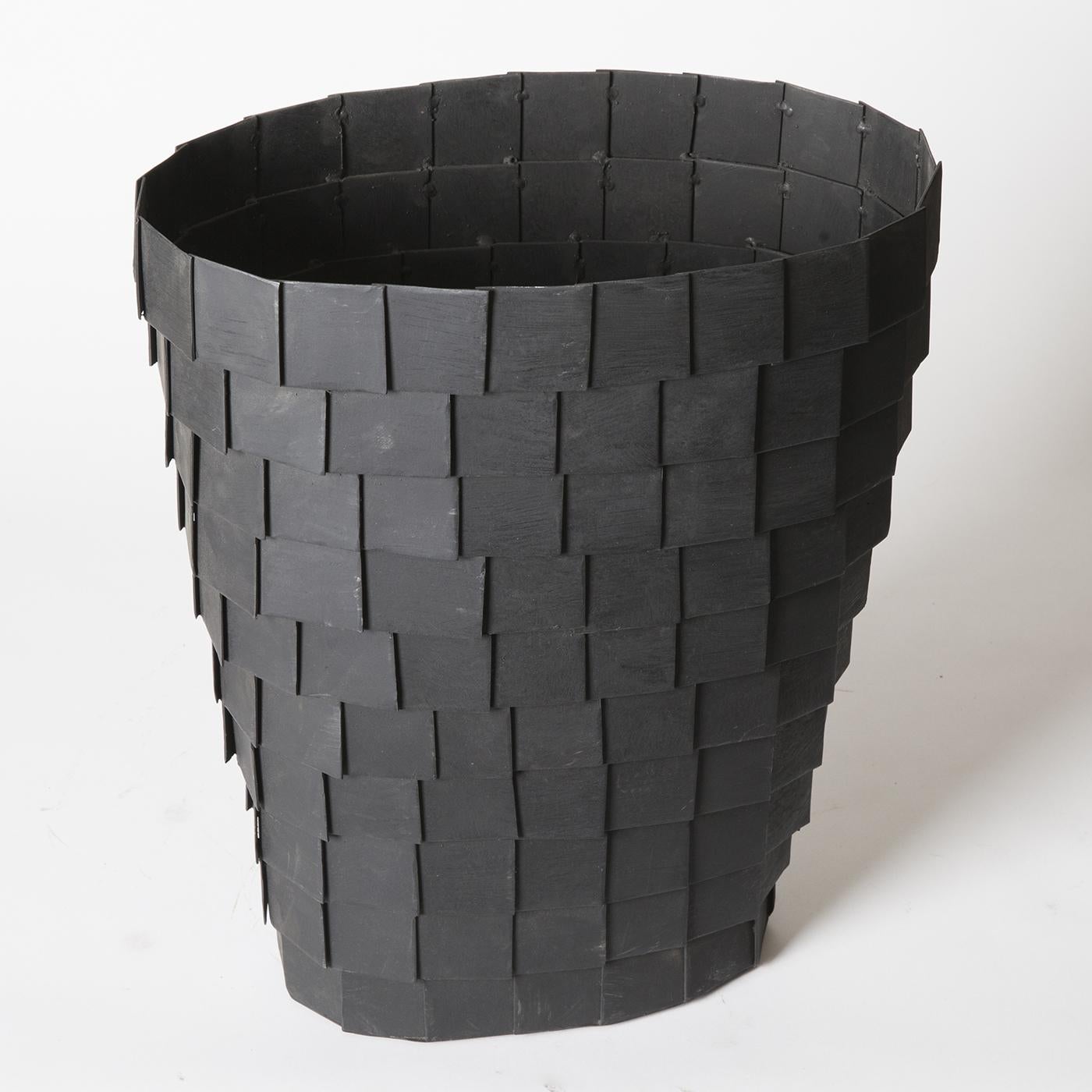 This dramatic piece by Sciortino is a truncated cone vase sculpture in panels of sheet iron, painted matte black to retain the impression of rough metal. 




       