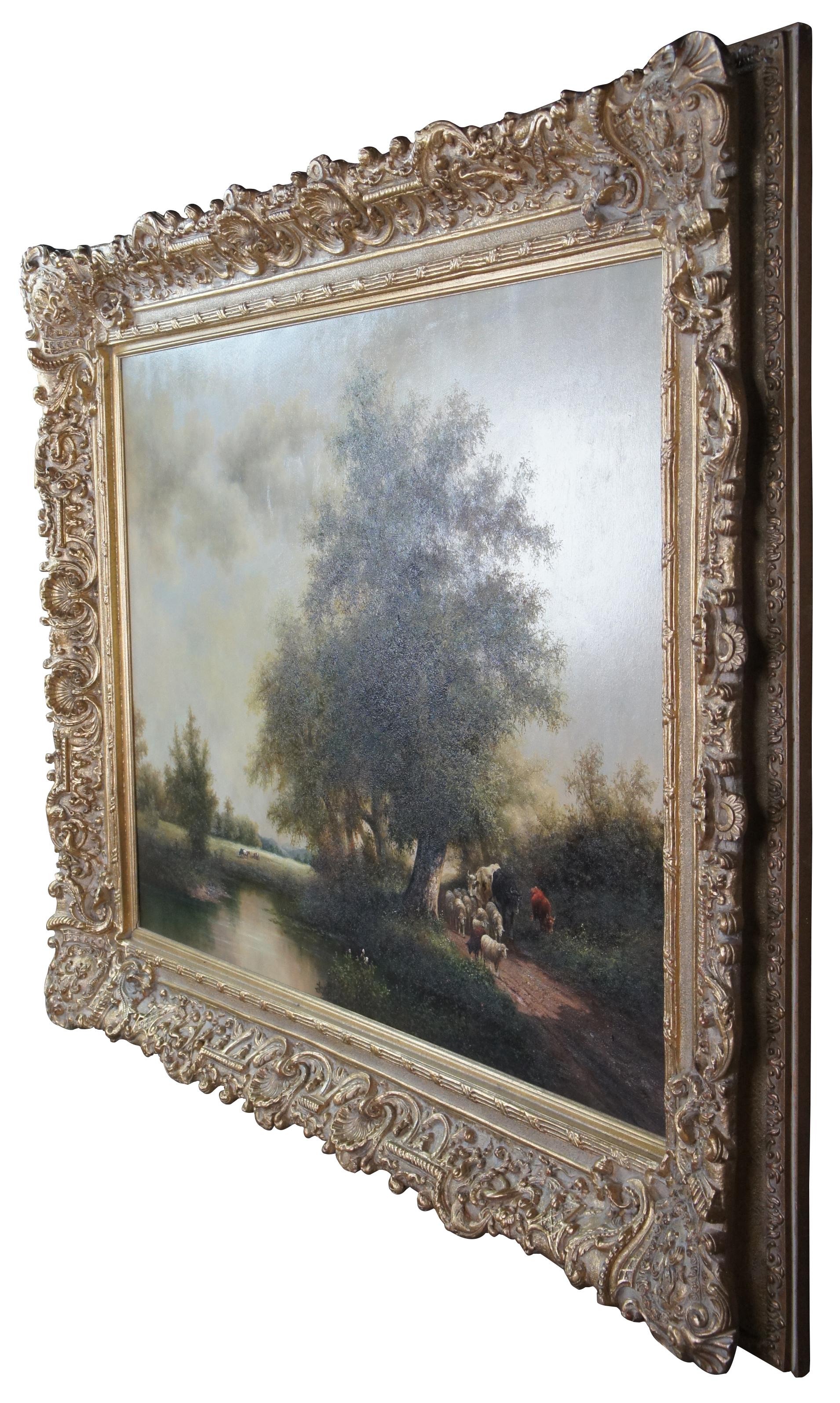 An impressive original vintage Impressionist landscape oil painting featuring cows and sheep grazing on a pasture or farm along a dirt road and lake. The ornate baroque gold frame features scalloping, shells, fleur de lis, and fluted ribbon accents.
