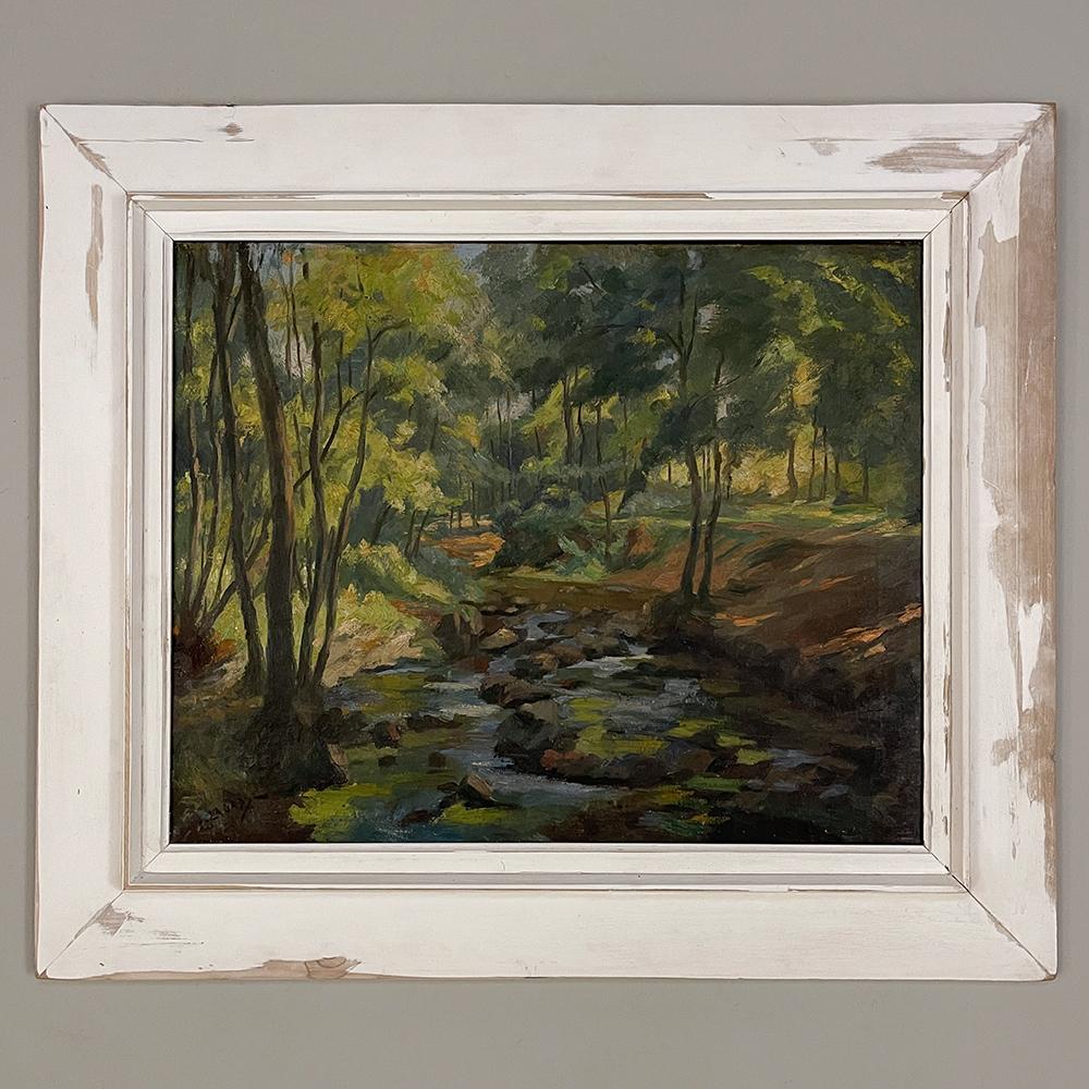 Impressionist oil painting on canvas in rustic distressed painted frame by Joseph Lagasse (1878-1962) is a superlative landscape wherein the artist has demonstrated his skill in using hues of color to depict natural beauty, perspective, and a