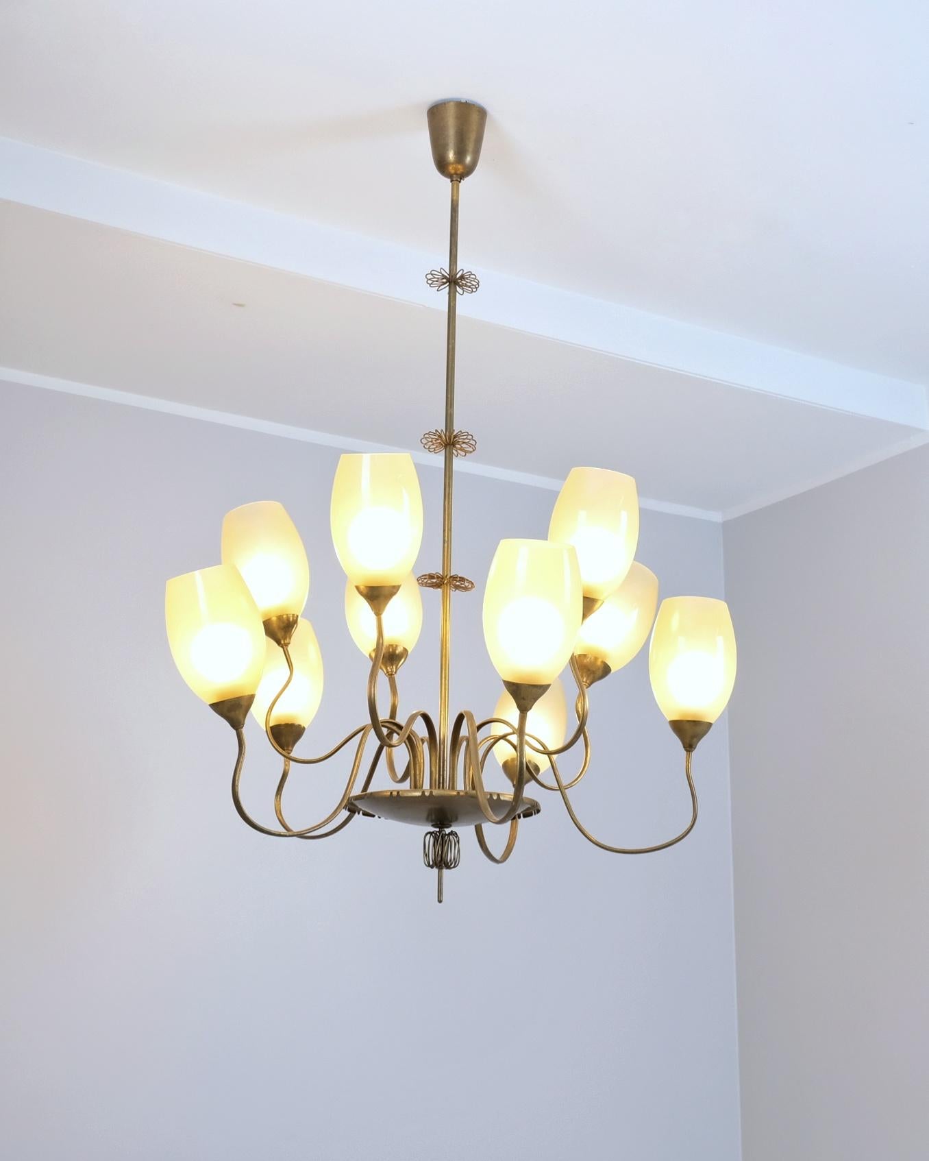 Un impressionante lampadario a dieci bracci a medusa modello 9017 di Paavo Tynell per Taito. Questa grande lampada da soffitto ha, come detto, dieci bracci ondulati di diverse altezze uniti al centro da un grande piatto in ottone con una decorazione