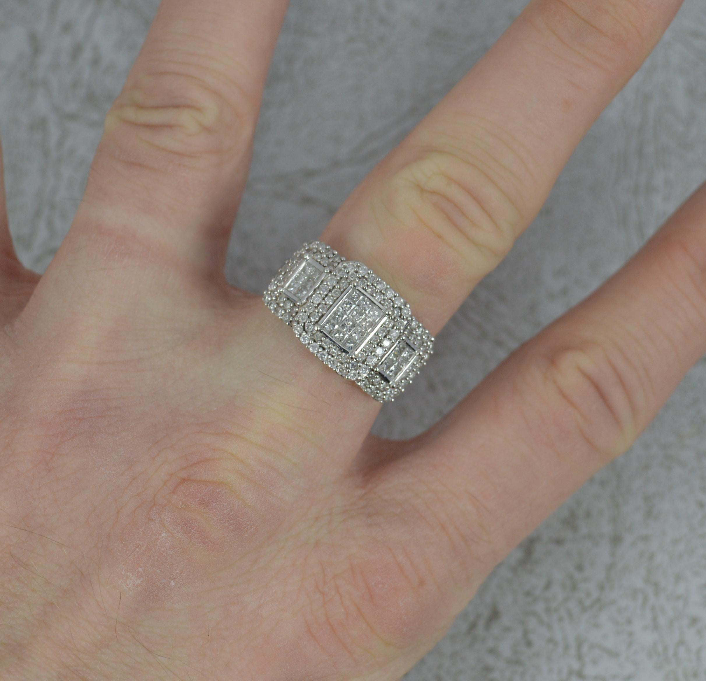 A stunning diamond cluster ring.
Solid and heavy 18 carat white gold example.
Designed with three clusters of princess cut diamonds with full borders of round brilliant cuts.
20mm x 12mm cluster head. Total weight of 1.00 carats as confirmed to the
