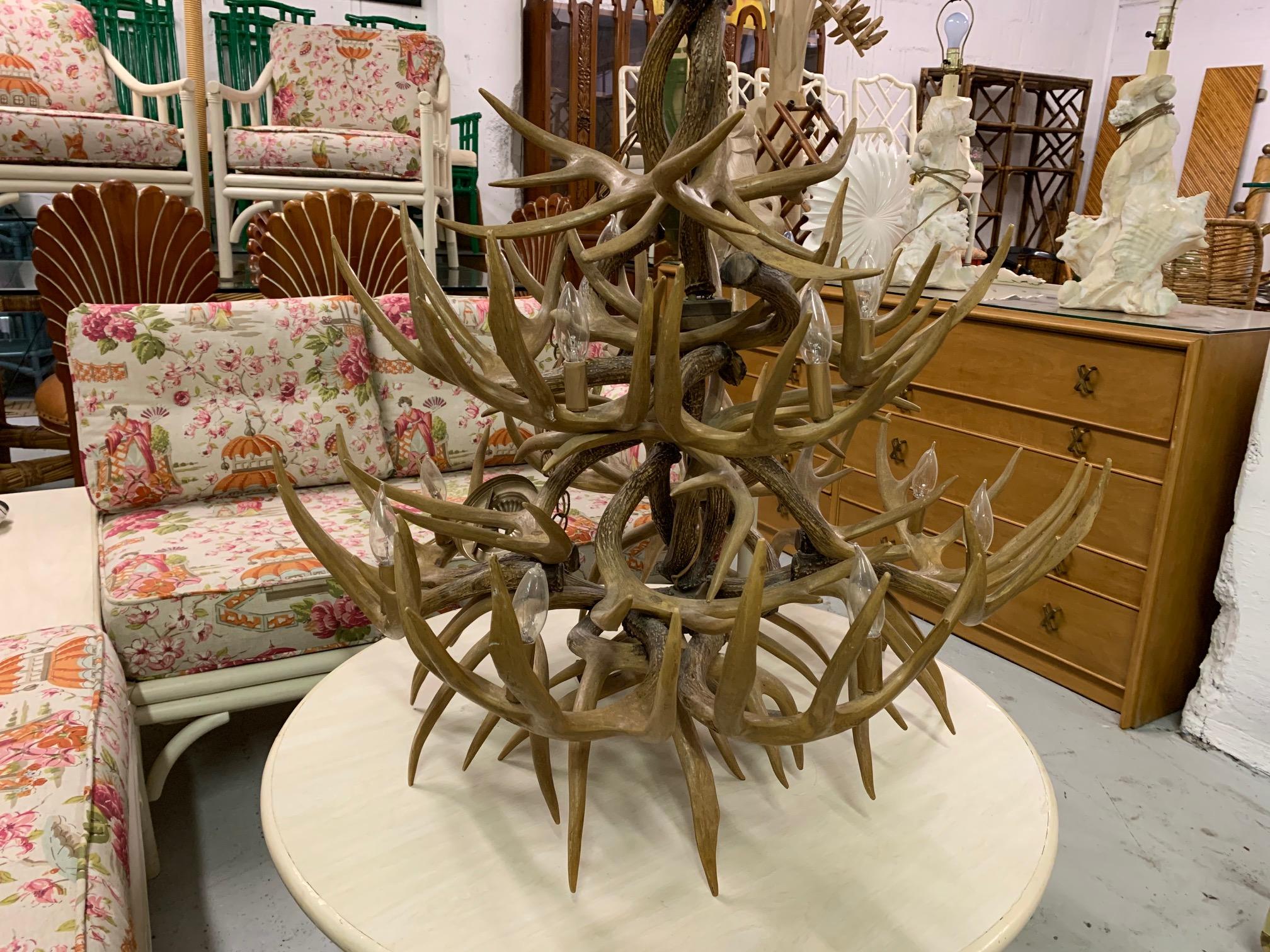 Large antler chandelier features 14-light and dozens of stag antlers. Handmade in the mid-20th century. Very good vintage condition with no flaws to speak of, and a warm natural patina.