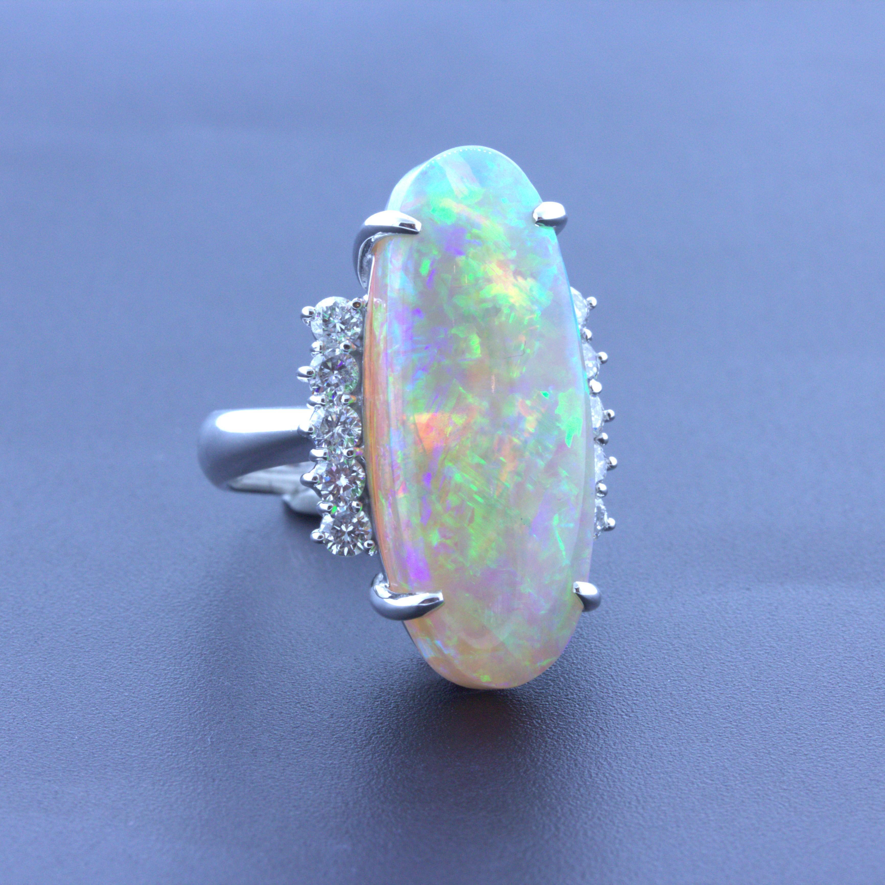 Simply stunning! This beautiful platinum ring features a large and impressive Australian opal with amazing play-of-color. The opal weighs a remarkable 15.36 carats while having incredible play-of-color as bright strong flashes of green, orange,