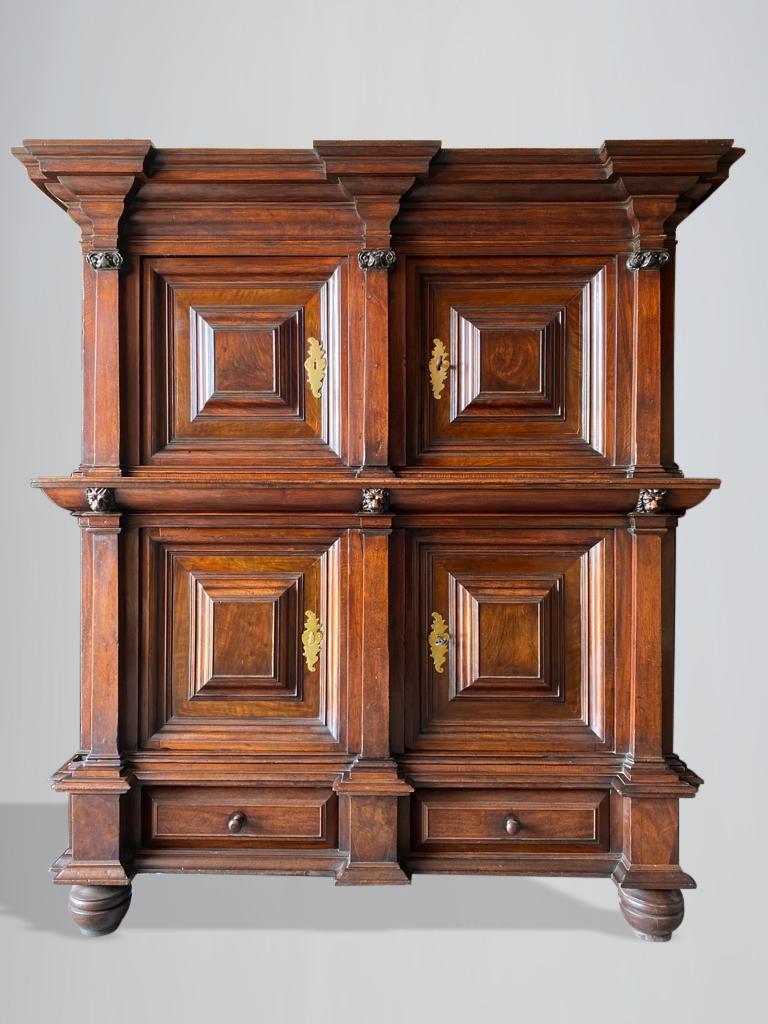 An impressive, unique and monumental late 17th century Dutch oak and walnut cupboard or kussenkast. Made of walnut on solid oak. The architectural shaped moulded cornice with shaped frieze. Above two doors with geometrically rectangular panels set