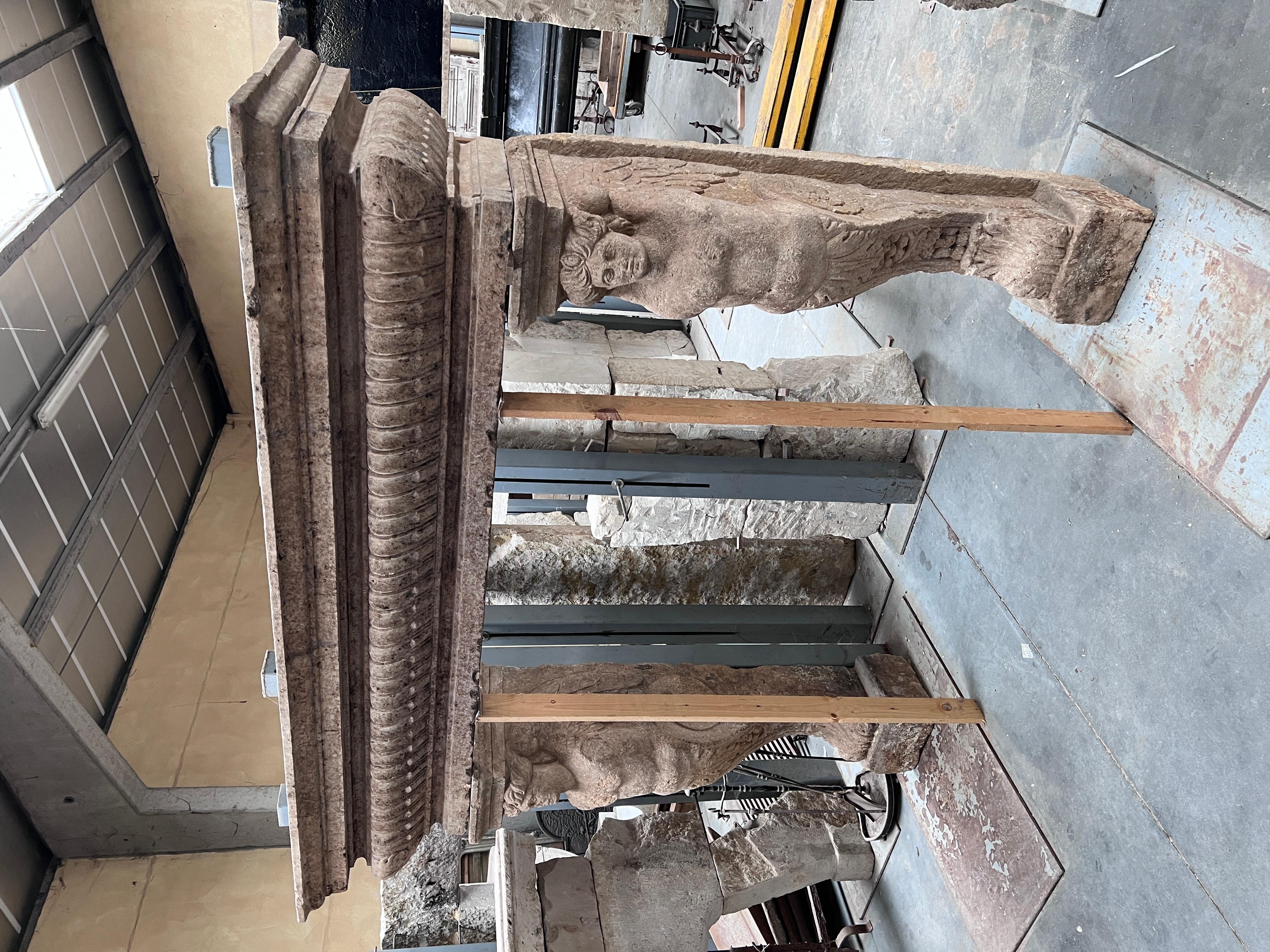 Very impressive Italian work. Limestone fireplace with beautiful patina and engraved caryatids, very detailed. circa 17th century. Exclusive, once in a lifetime piece. 
Exterior dimensions: W 209 cm H 185 cm
Interior dimensions: W 133 cm H 142 cm.