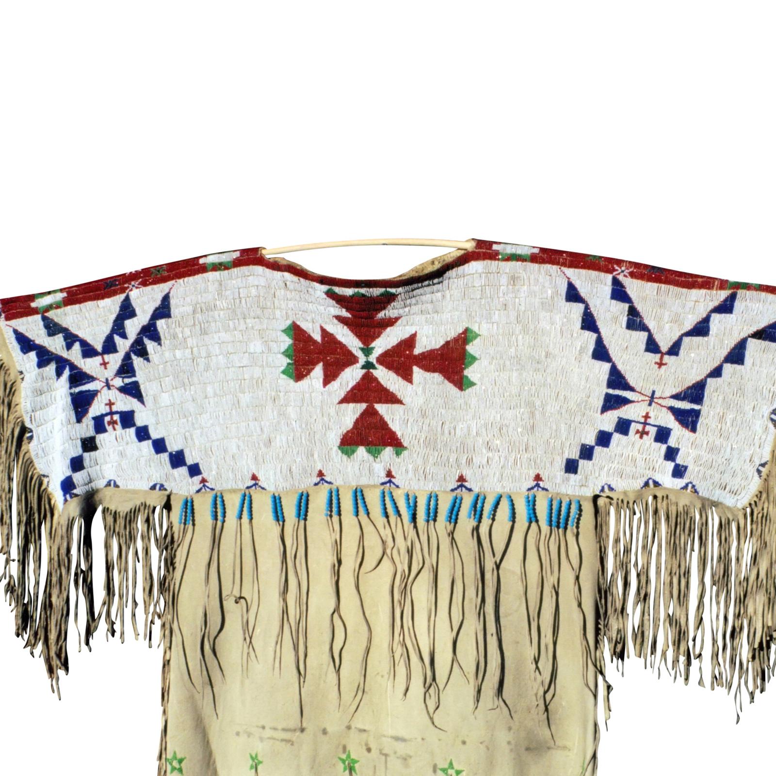 Faceted Beads; Arapaho/Sioux dress on brain-tanned buffalo. Simple four color design; was probably the first dress made after quilling. Stars on dress, and unusual beaded bottom.

Period: 1870s

Origin: Arapaho/Sioux Plains

Size: 42