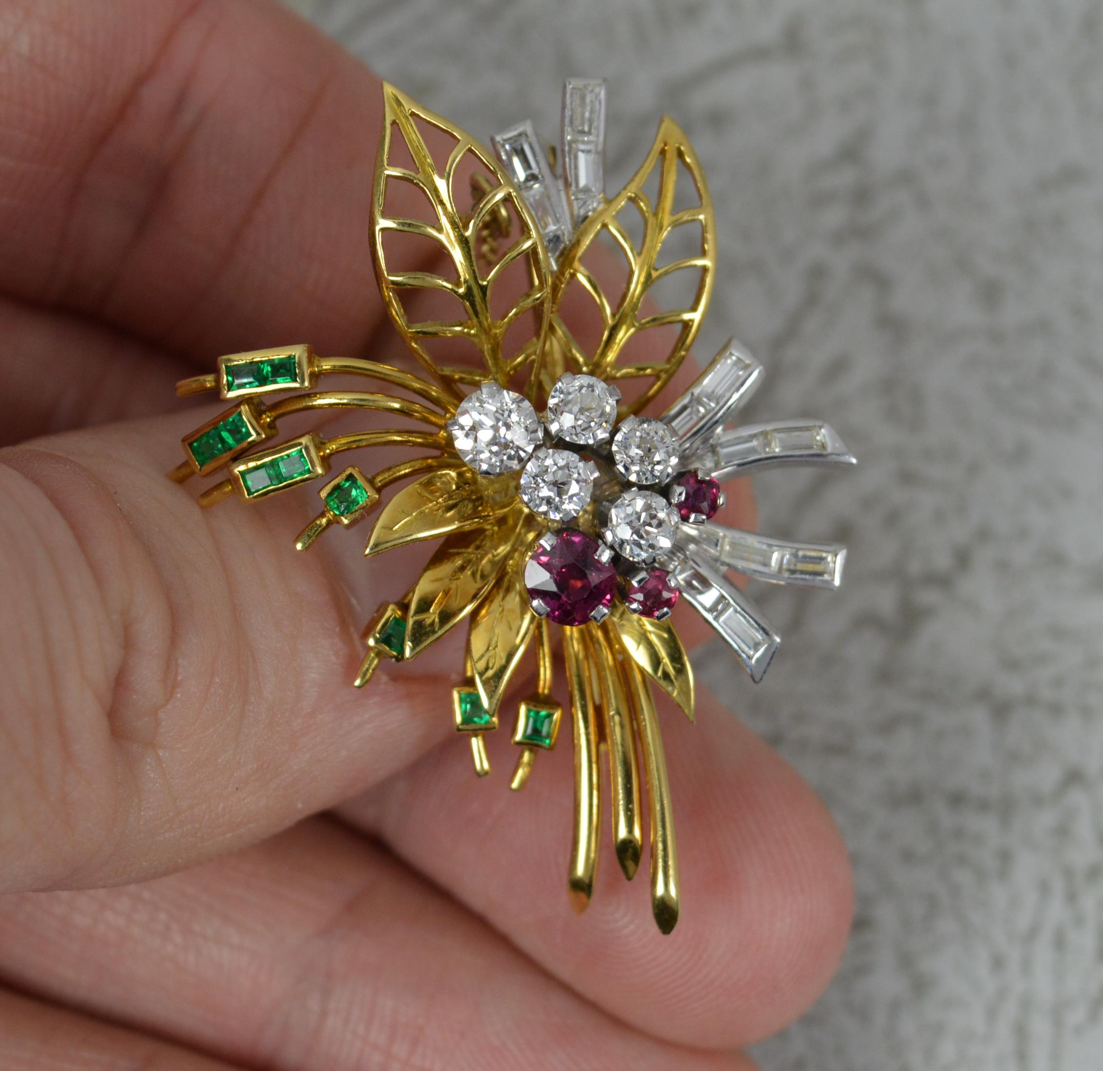 A stunning Art Deco period bar brooch. Circa 1950/60.
Solid 18 carat yellow gold example with platinum setting.
Designed as a vivid colourful floral spray brooch. To the centre are natural old cut diamonds and bright round cut rubies. Surrounding