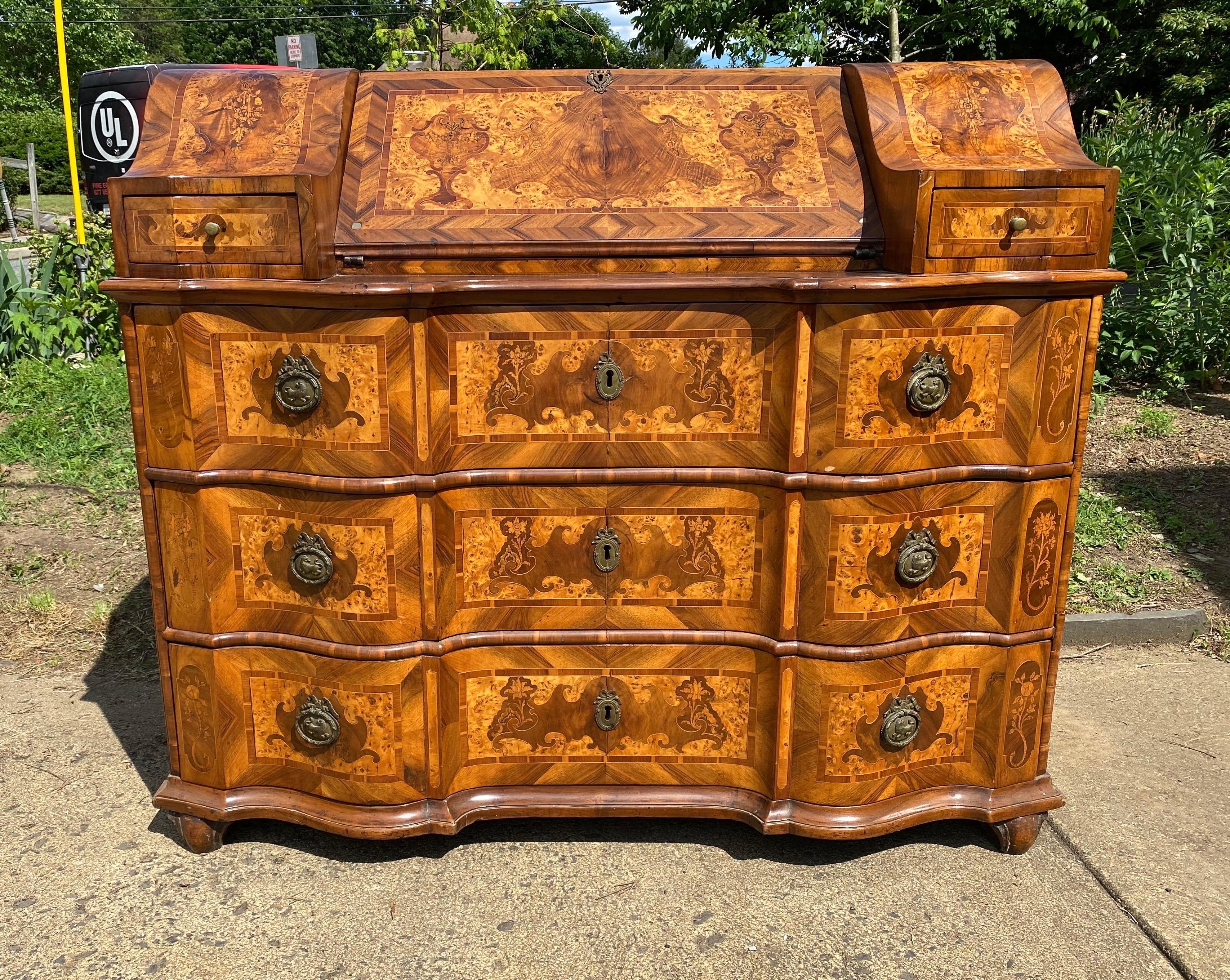 Impressive 18th century northern Italian inlaid bureau with secretary desk. Incredible inlay work with walnut, burl walnut, olive wood and other exotic imported veneers. 3 drawers beneath the fall front desk. The desk is flanked on either side with