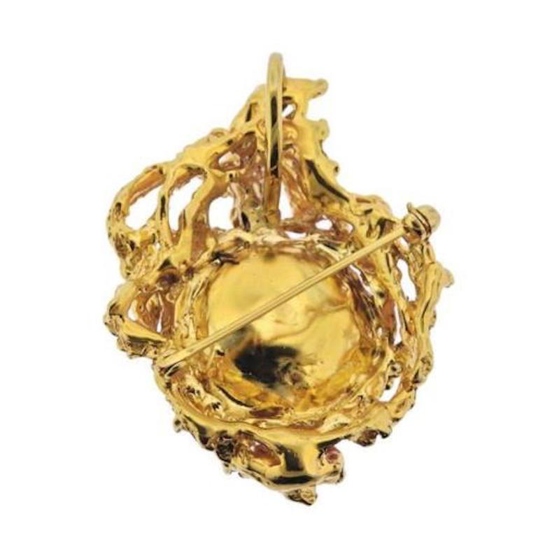 Impressive 1970s retro 14 karat gold coral cabochon diamond freeform naturalistic brooch / pendant.   

This gorgeous sizable brooch is set with a substantial circular coral cabochon and approximately 0.30 carats of brilliant cut diamonds.  

The