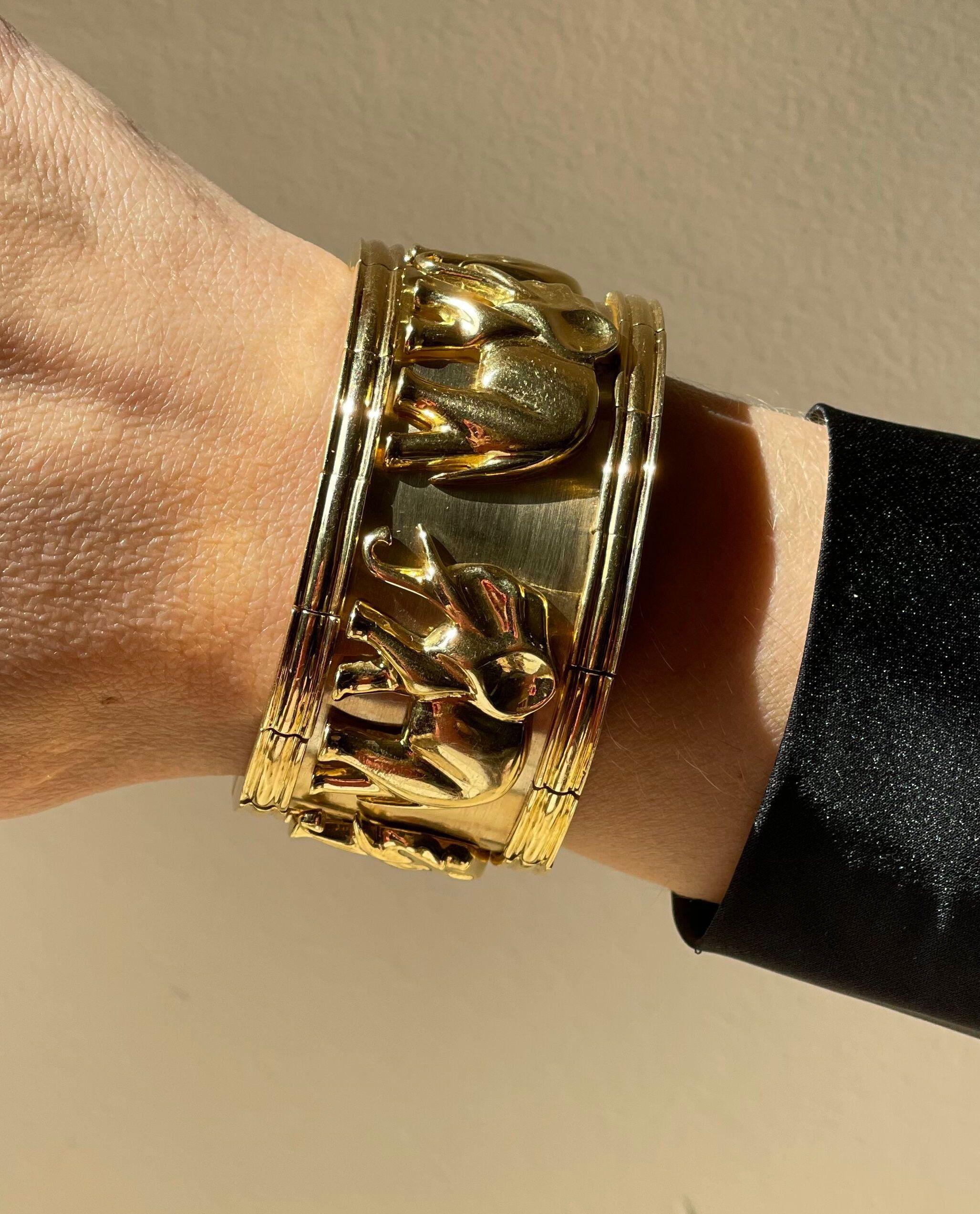 Impressive and heavy 18k gold cuff bracelet, depicting elephants. Bracelet will fit an average size wrist, approx. 7