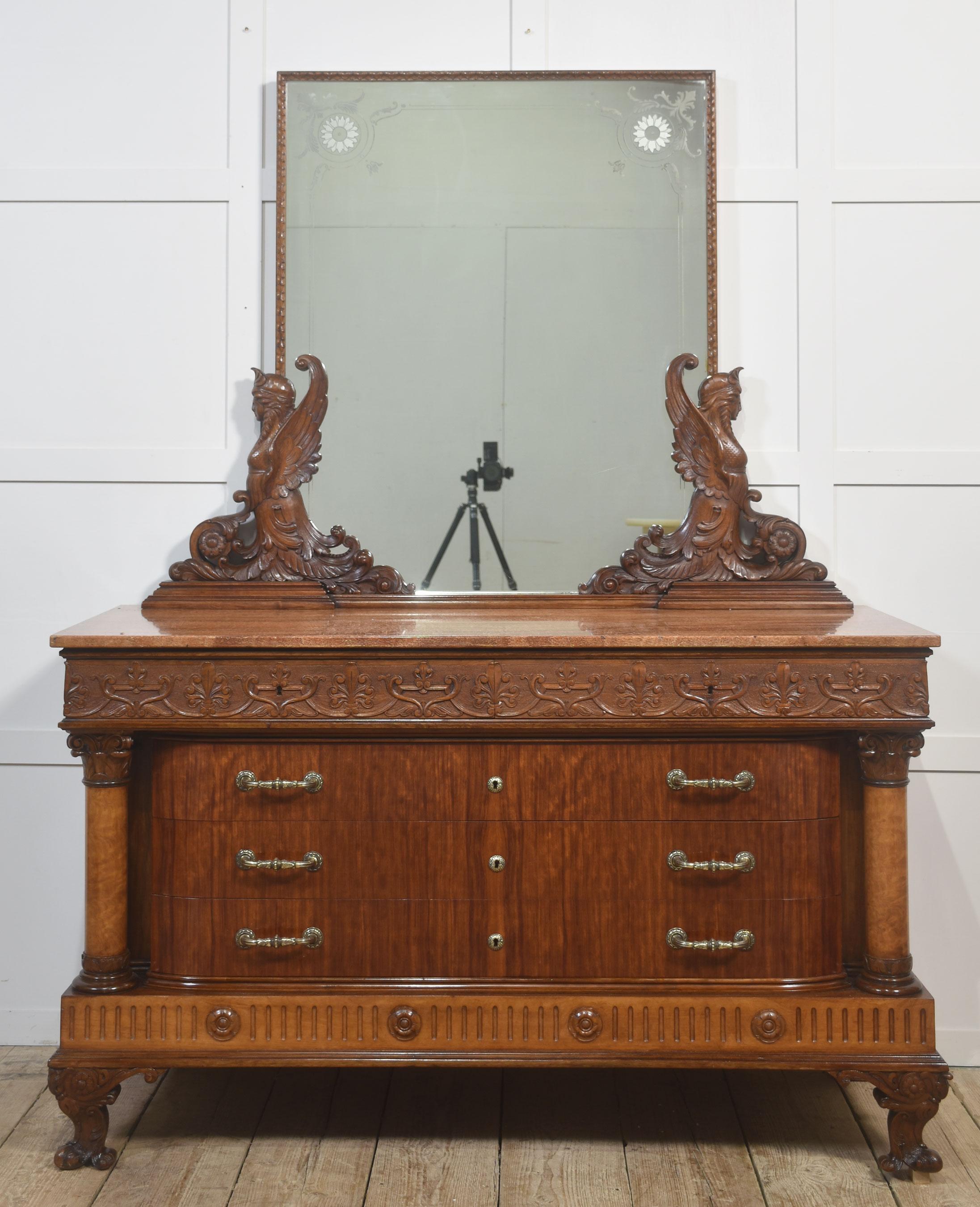 Impressive 19th-Century Mahogany Dressing Chest with Marble Top and Carved Winged Caryatids
A magnificent late 19th-century mahogany dressing chest featuring a richly figured marble top and an imposing mirror supported by finely carved winged female