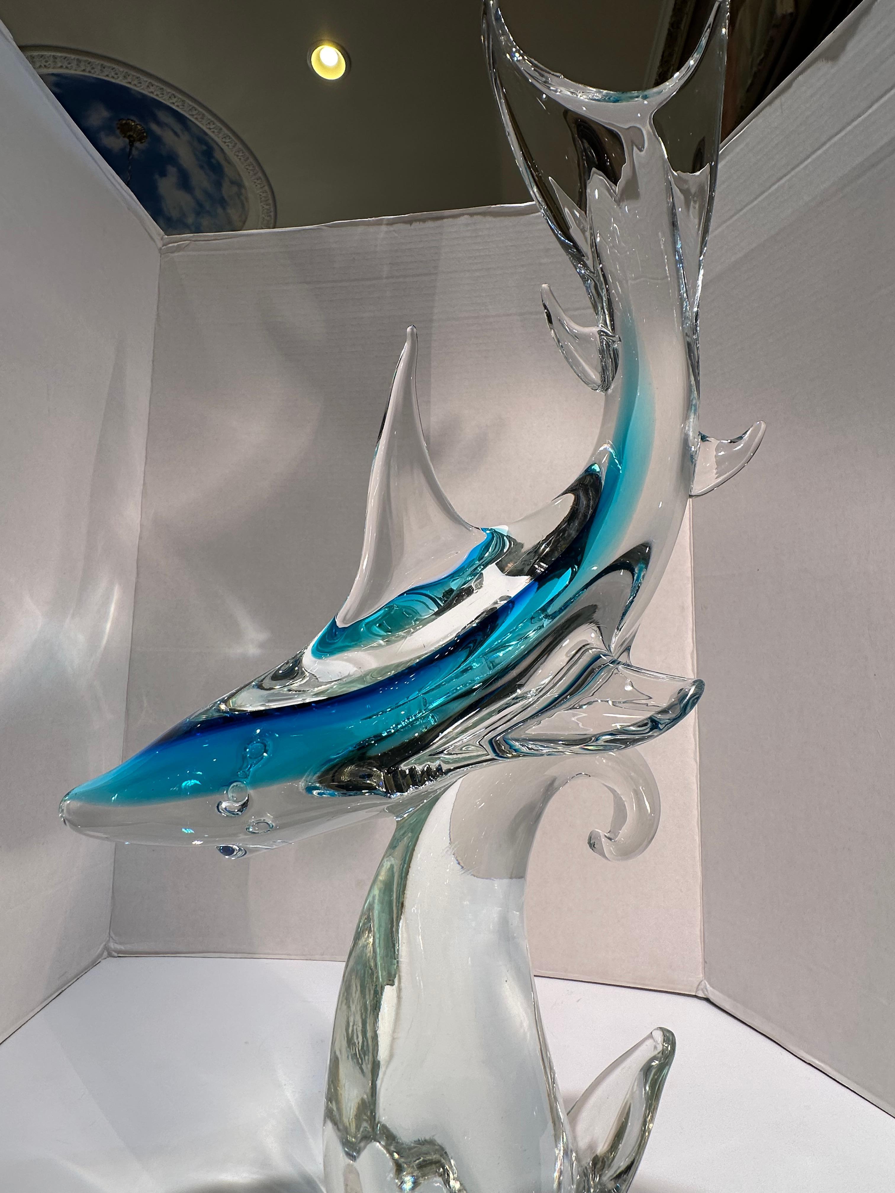 Very impressive, hand made and mouth blown in Italy, Murano art glass figure or sculpture of a shark in a very vibrant Caribbean blue color, with clear fins that have blue penetrating in, set on a free flowing clear glass wave plinth. This is a very