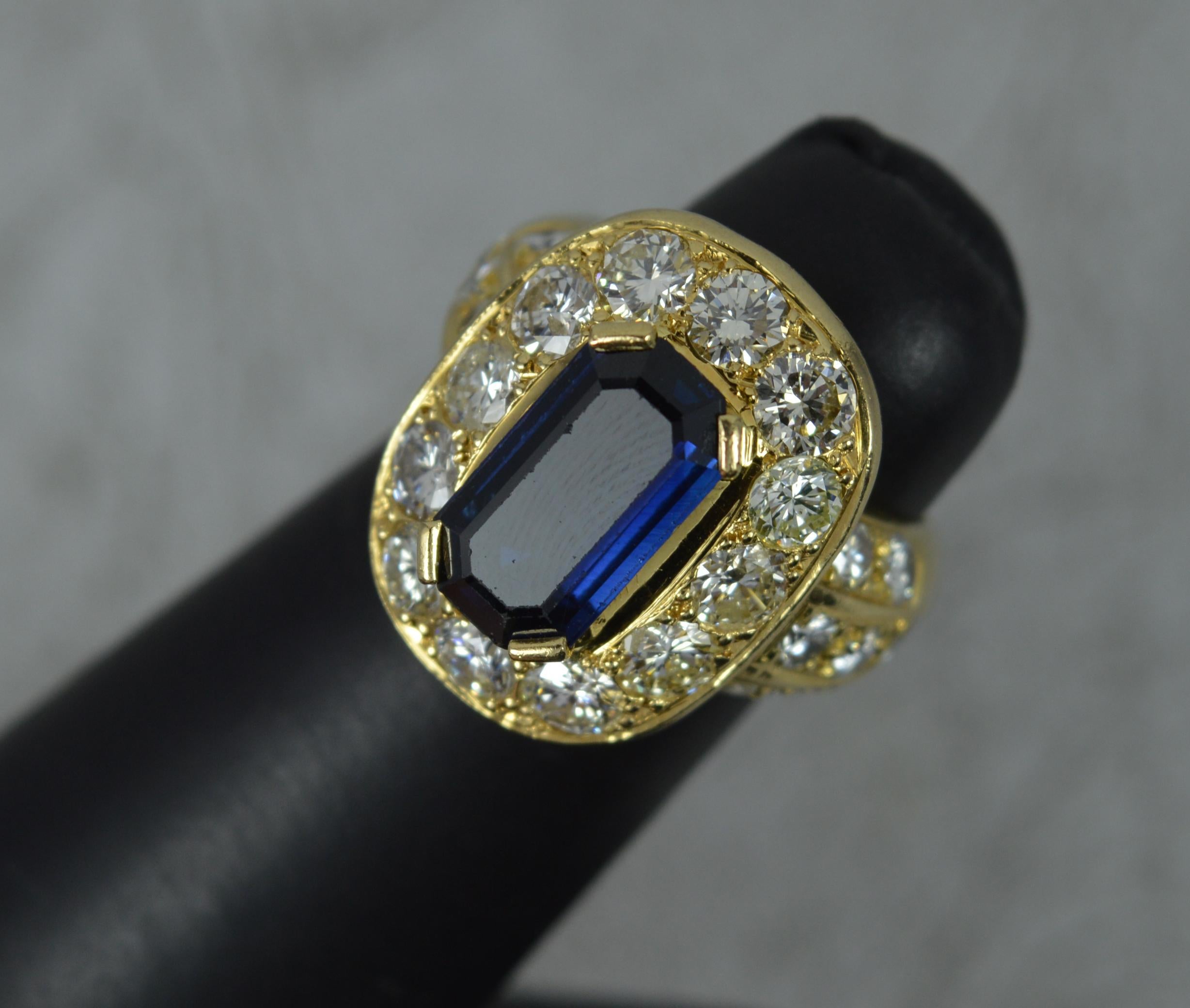 A fantastic quality 18ct gold, sapphire and diamond ring.
Very heavy 18 carat yellow gold example.
Set with an elongated emerald cut blue sapphire. 6.5mm x 12.4mm approx, in four claw head. Surrounding are twelve larger round brilliant cut diamonds,