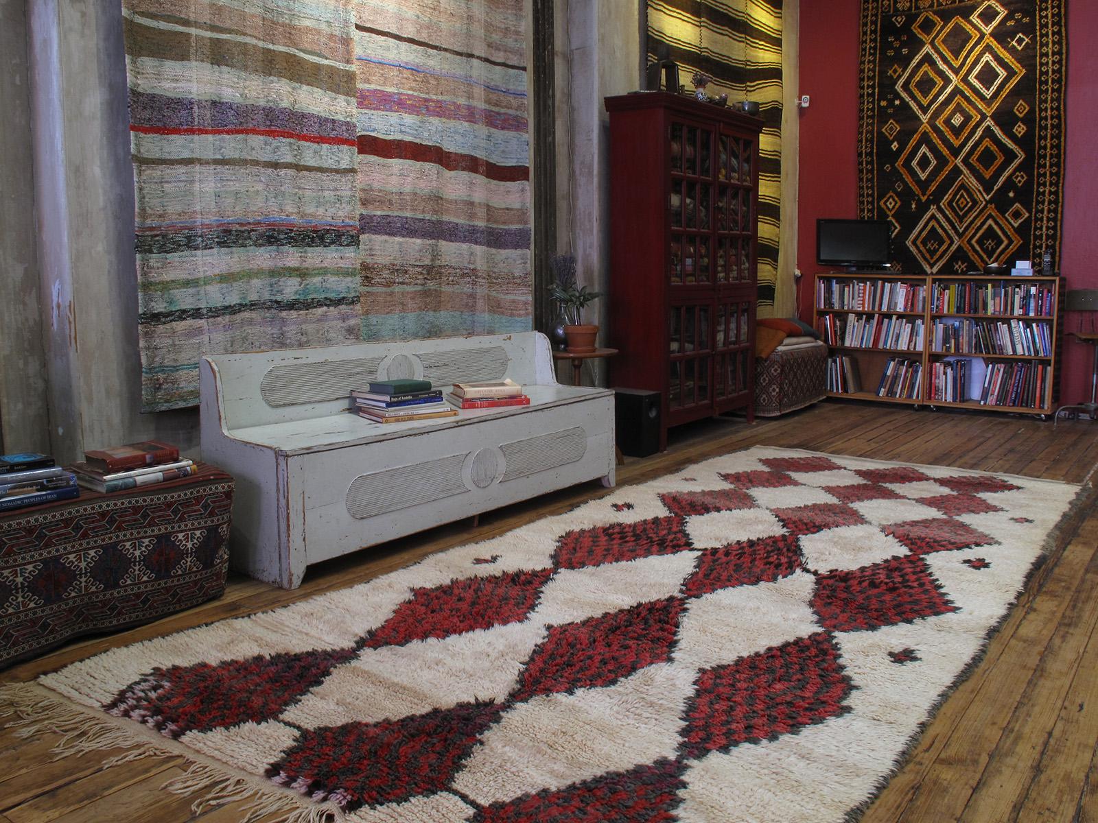 An impressive Moroccan Berber carpet, attributed to the Ait Bou Ichaouen tribes of eastern High Atlas, with rare white ground color and generous proportions.