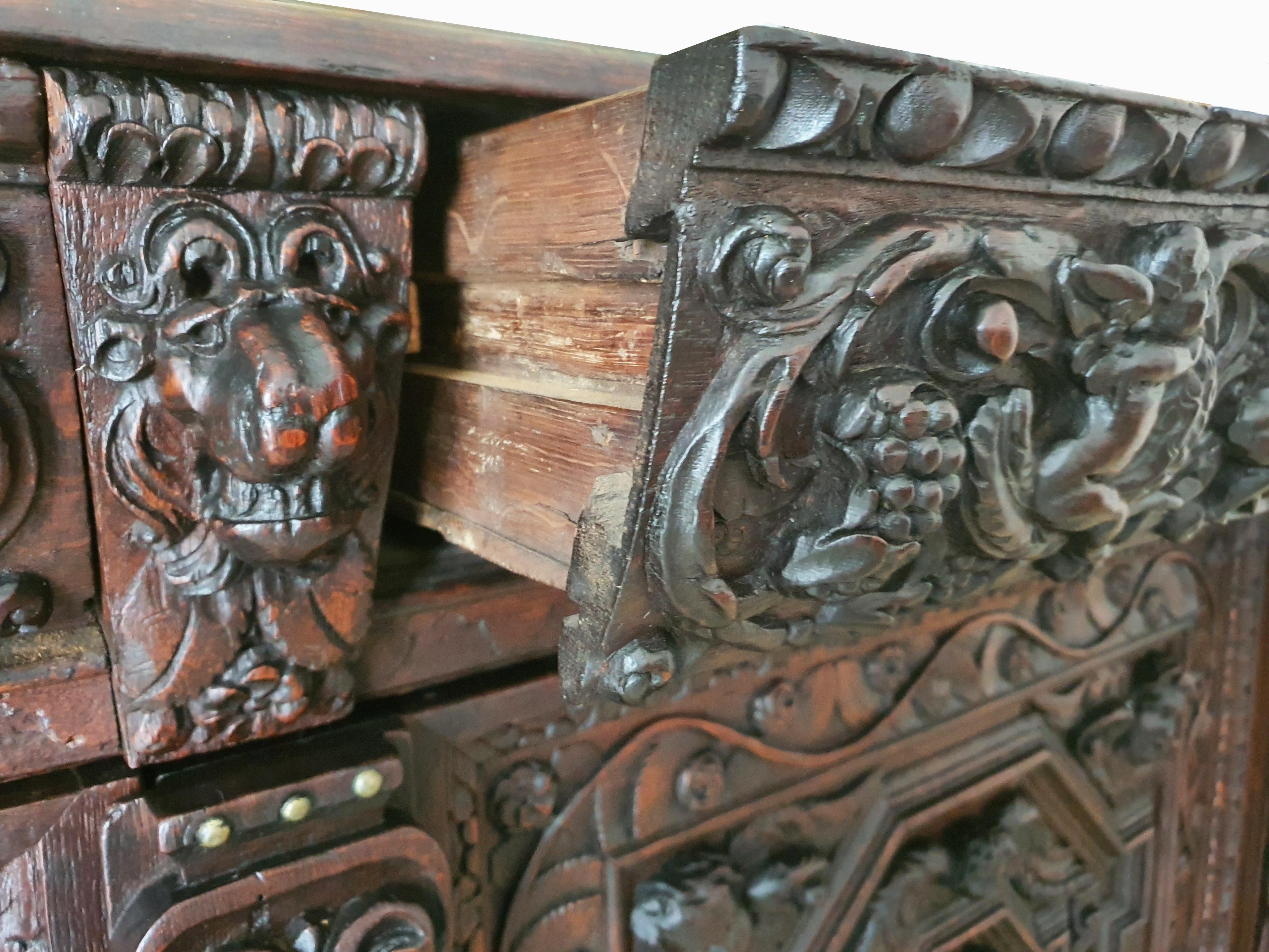 Outstanding 17th Century Flemish Oak Buffet of Impressive proportions. With fine, deeply carved drawers displaying putti and floral decoration above a two door cupboard with geometrically applied moldings and winged putti applied to the top corners.