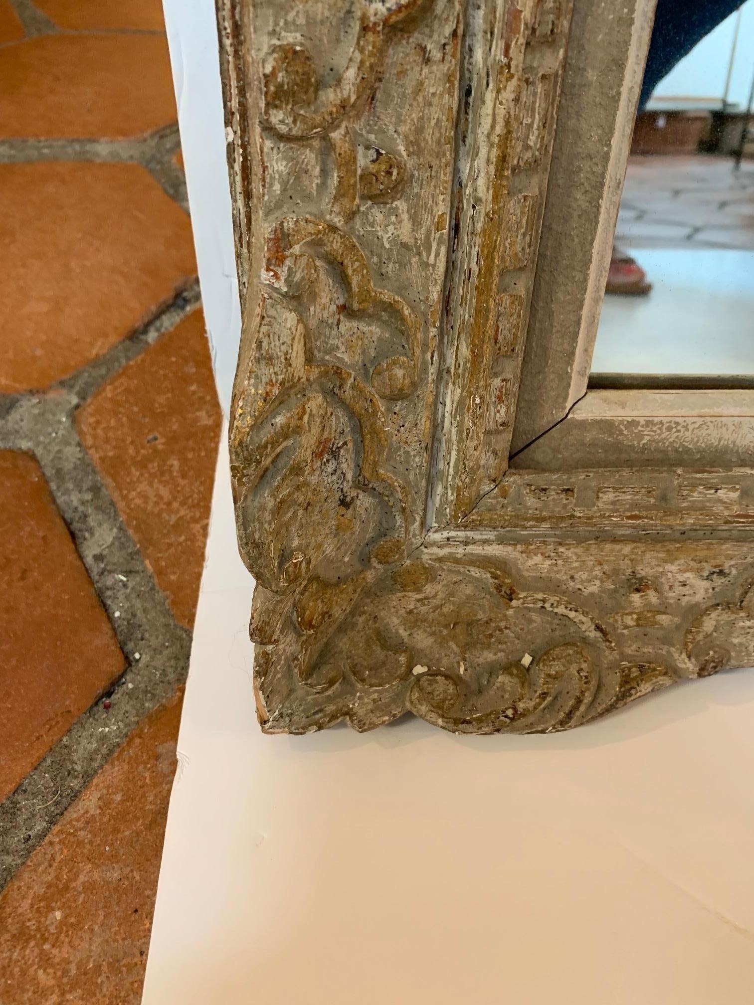 Large and lovely aged carved wood French rectangular mirror having fascinating original chalky white paint with grey and traces of gold.