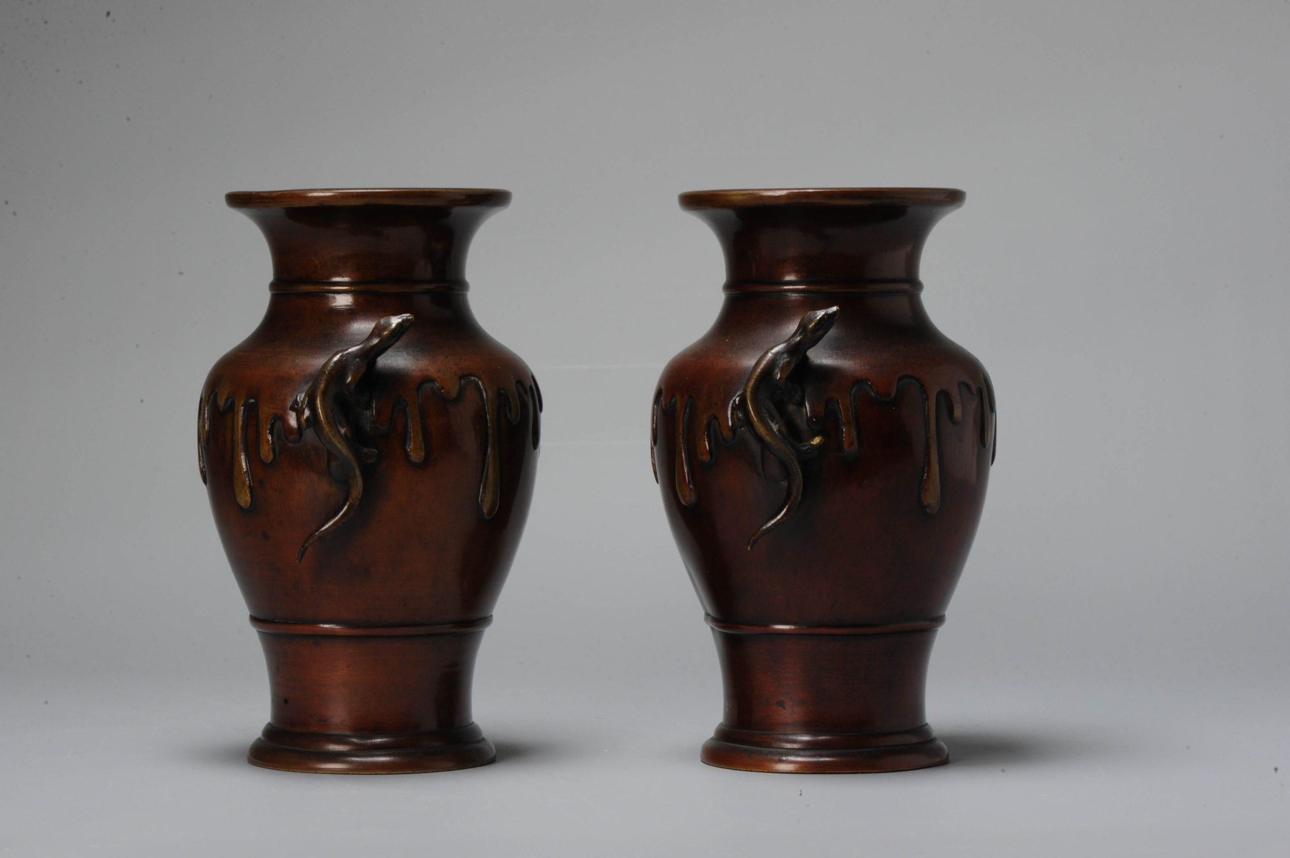 Very artistic Japanese bronze vases with drip design reminiscent of an overflowing jar. Beautiful patina. Handles are salamanders climbing the vases.

These pieces are difficult to photograph, pictures in natural light added.

Marked at