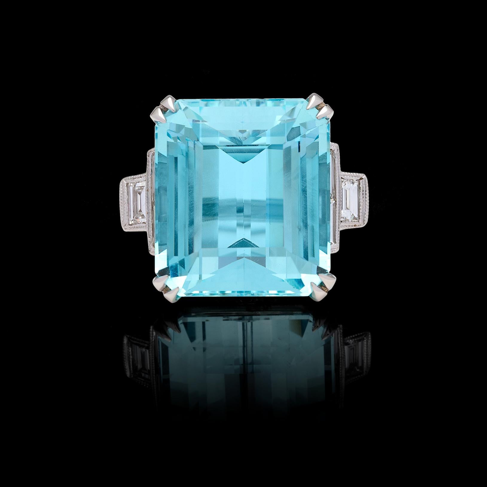 Feel like royalty! This stunning and stately 18k white gold ring features the 25.39 carats crystal blue rectangular-cut aquamarine, set in a one-of-a-kind platinum mount, with 6 baguette and 28 round brilliant-cut diamonds, weighing together an