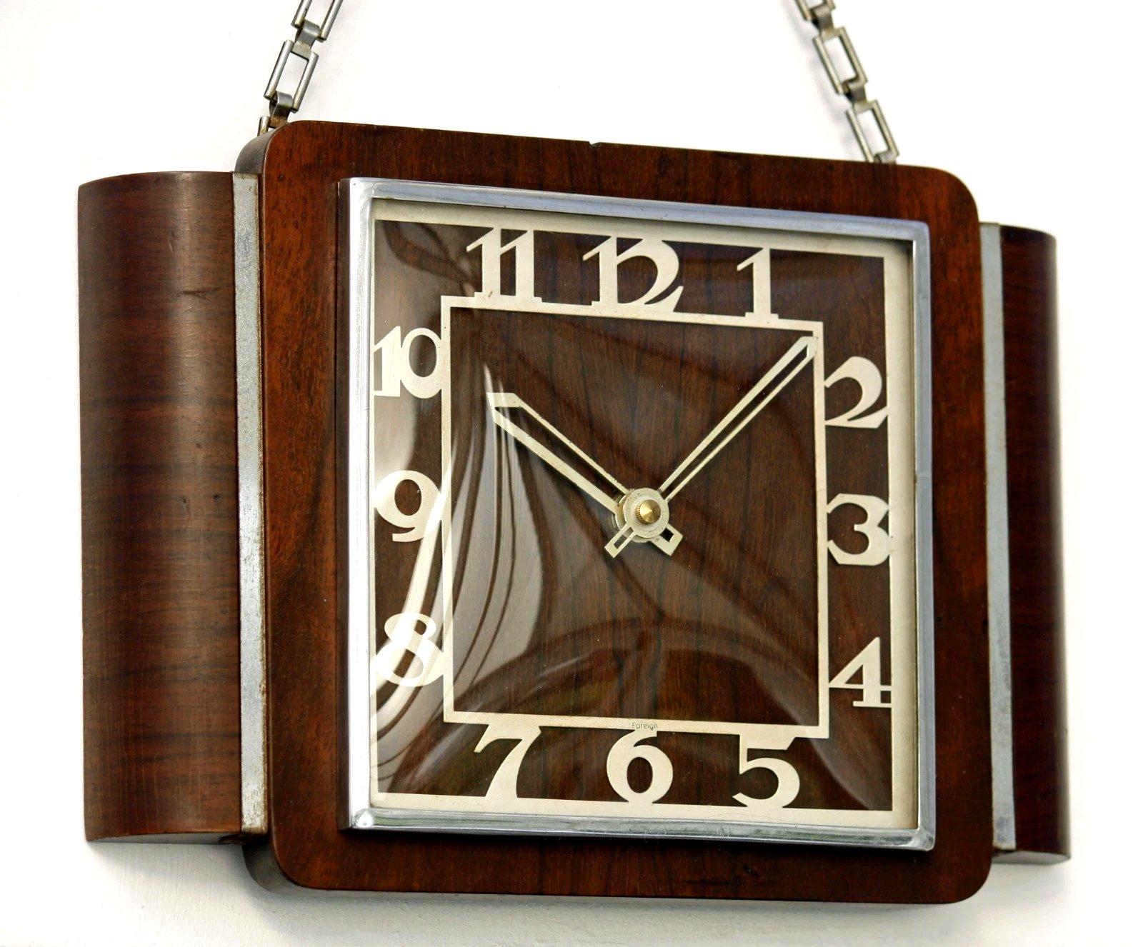 For your consideration is this original Art Deco wall clock. The body of the clock is a straight grain walnut with cream enamel Art Deco style numerals and chrome bezel. Originally had an electrical movement which we've converted to battery - uses