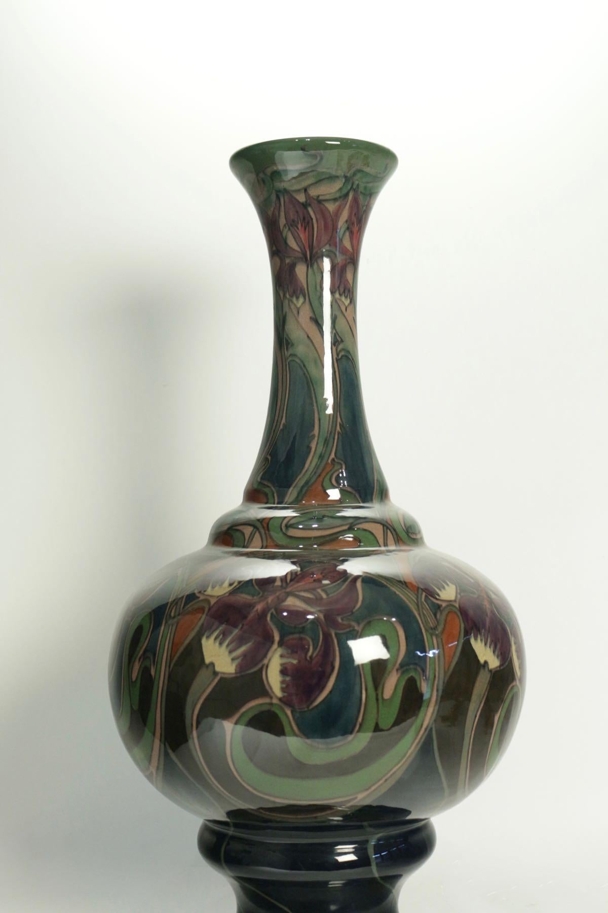Very Impressive and decorative Art nouveau ceramic vase 
Gouda Zuid Holland factory established in 1898.
Unique Art Nouveau vase in glazed ceramic with hand-painted design of stylized tulips and irises
Signed under the base and monogrammed D d J for