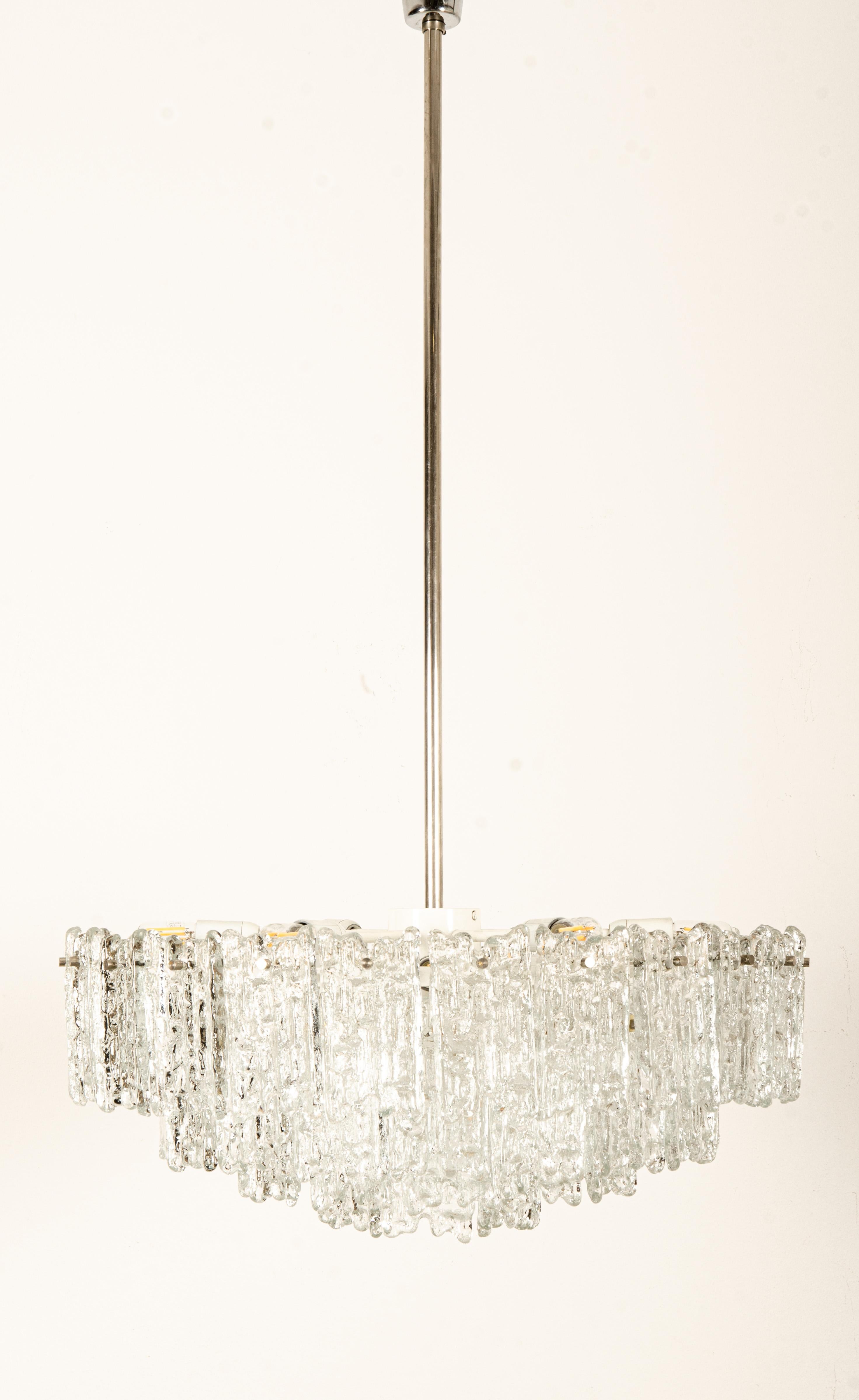 Large and heavy steel construction with 15 lights and crystal ice glass elements. Made in Austia in the 1960s by J.T. Kalmar model ARENA.
  