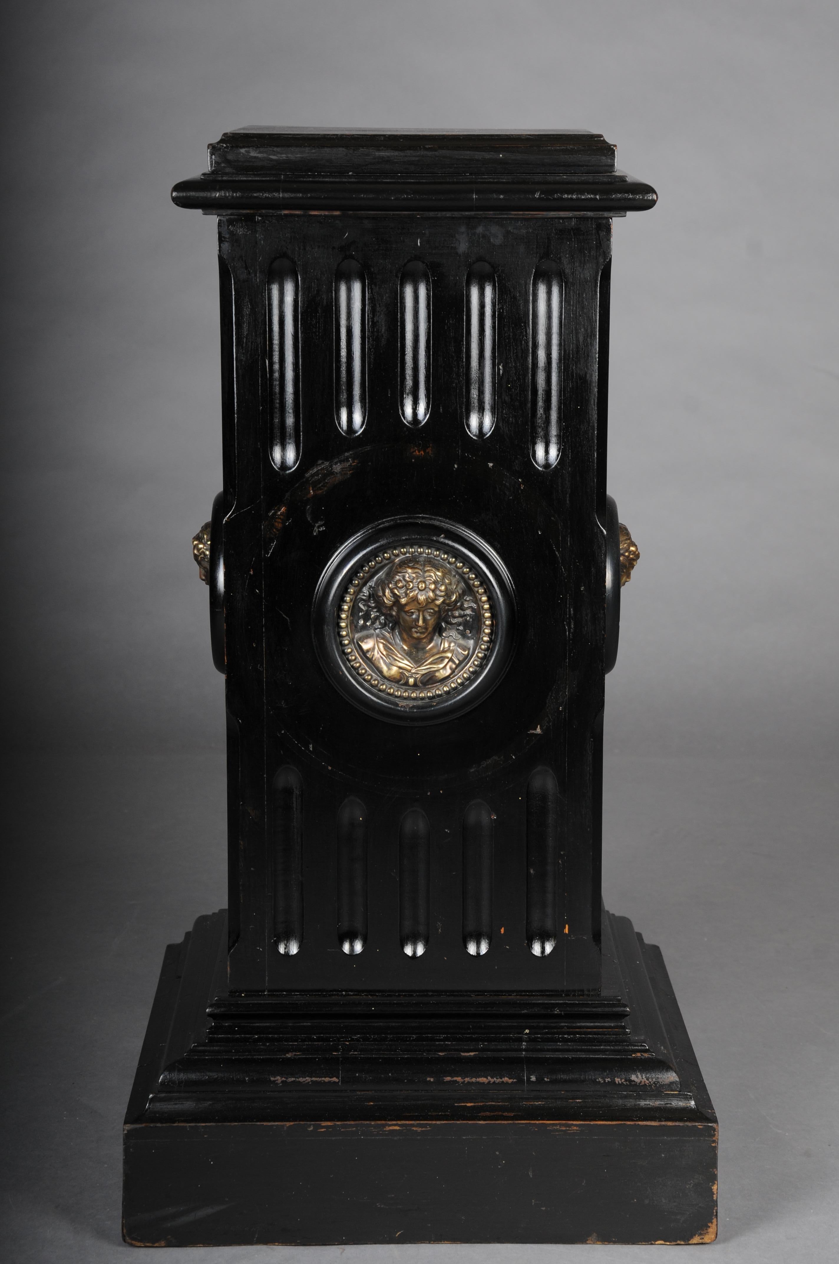 Impressive black pedestal made of ebonized solid wood, circa 1860s

Solid wood, square body with a profiled and stepped base. A round portrait medallion is framed in the center of each side.

This column is a real eye-catcher and looks very elegant