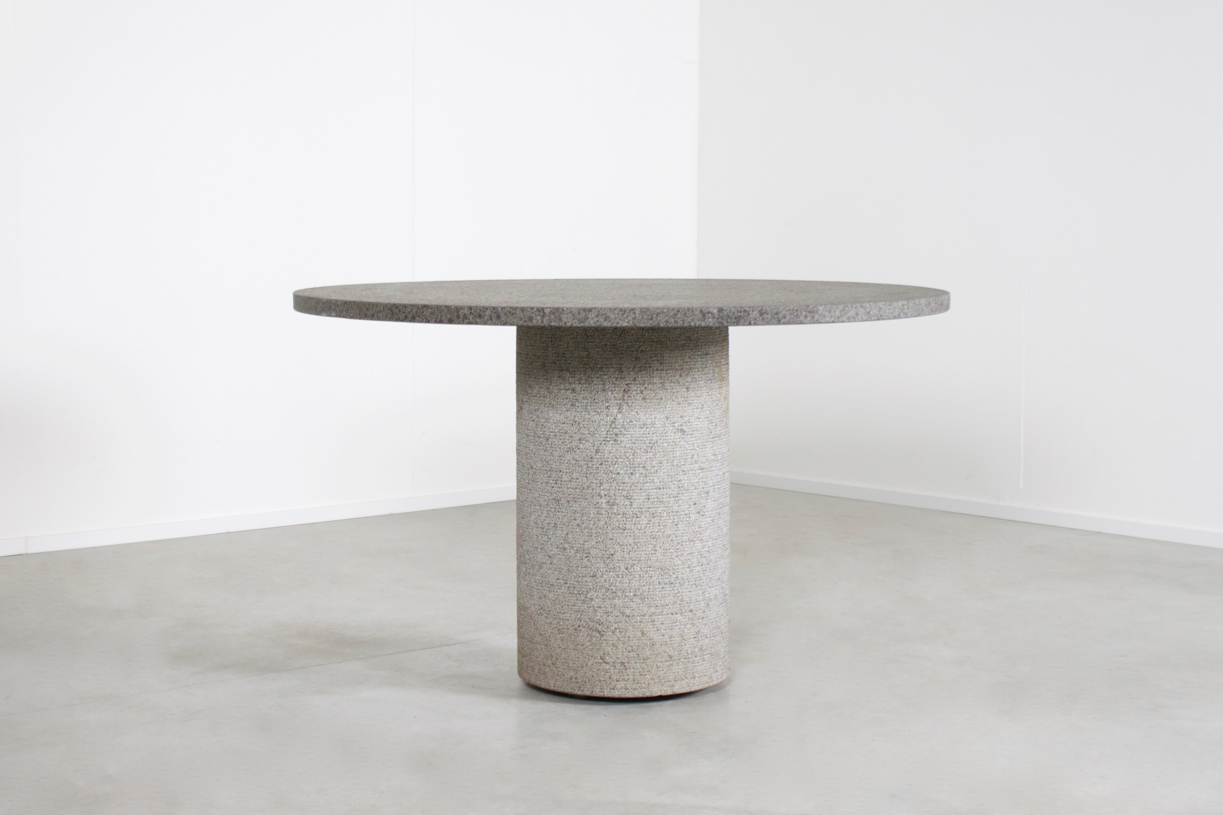 Round center/dining table in very good condition.

Made in Belgium in the 1970s 

The table is made of Belgian bluestone which gives it an impressive Brutalist look.

The bluestone has a beautiful rough structure which adds to the Brutalist