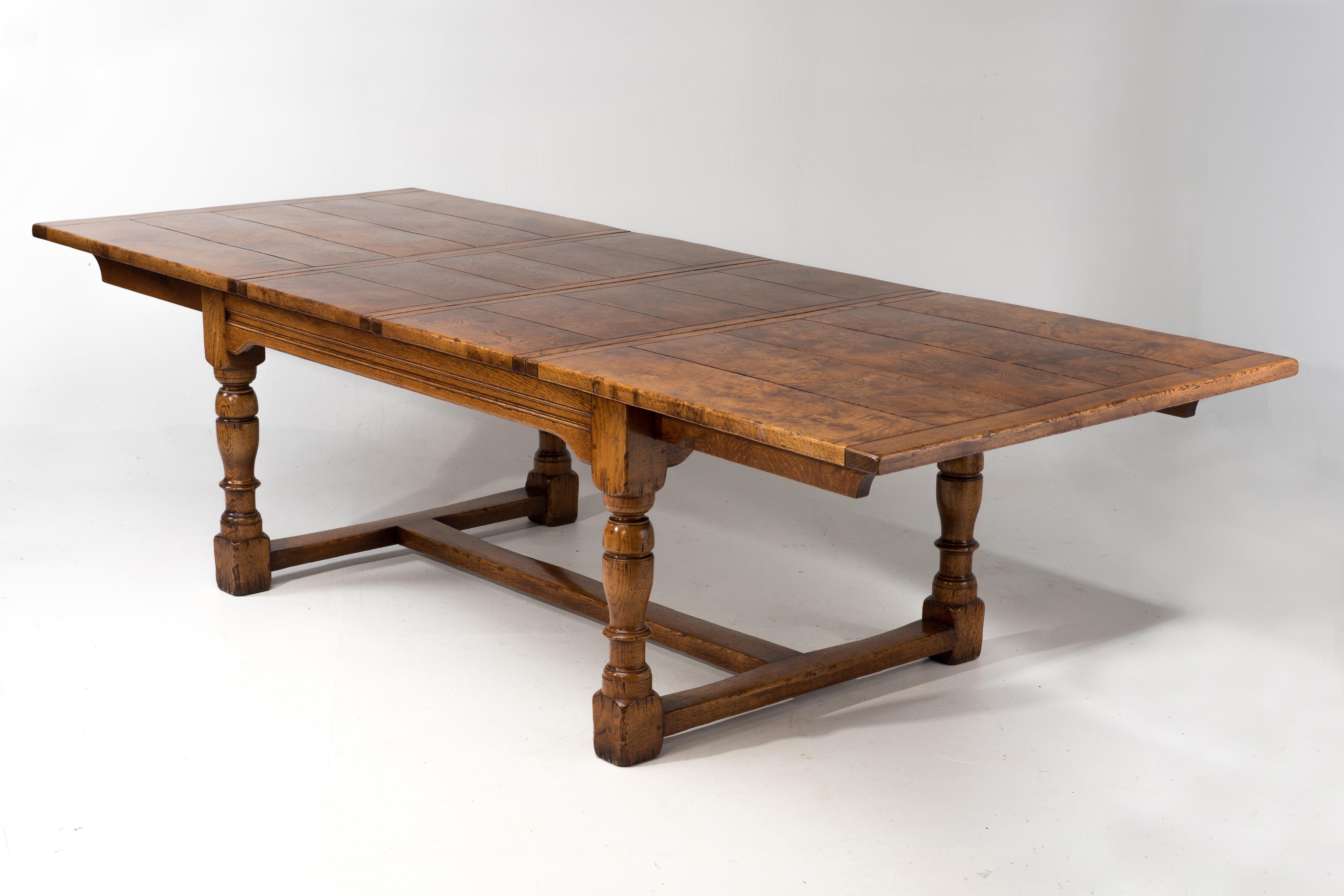 Turn of the century burled wood refectory dining table with two removeable leaves,  turned chunky legs and stretcher.  Large, heavy and Thanksgiving worthy.
111.4